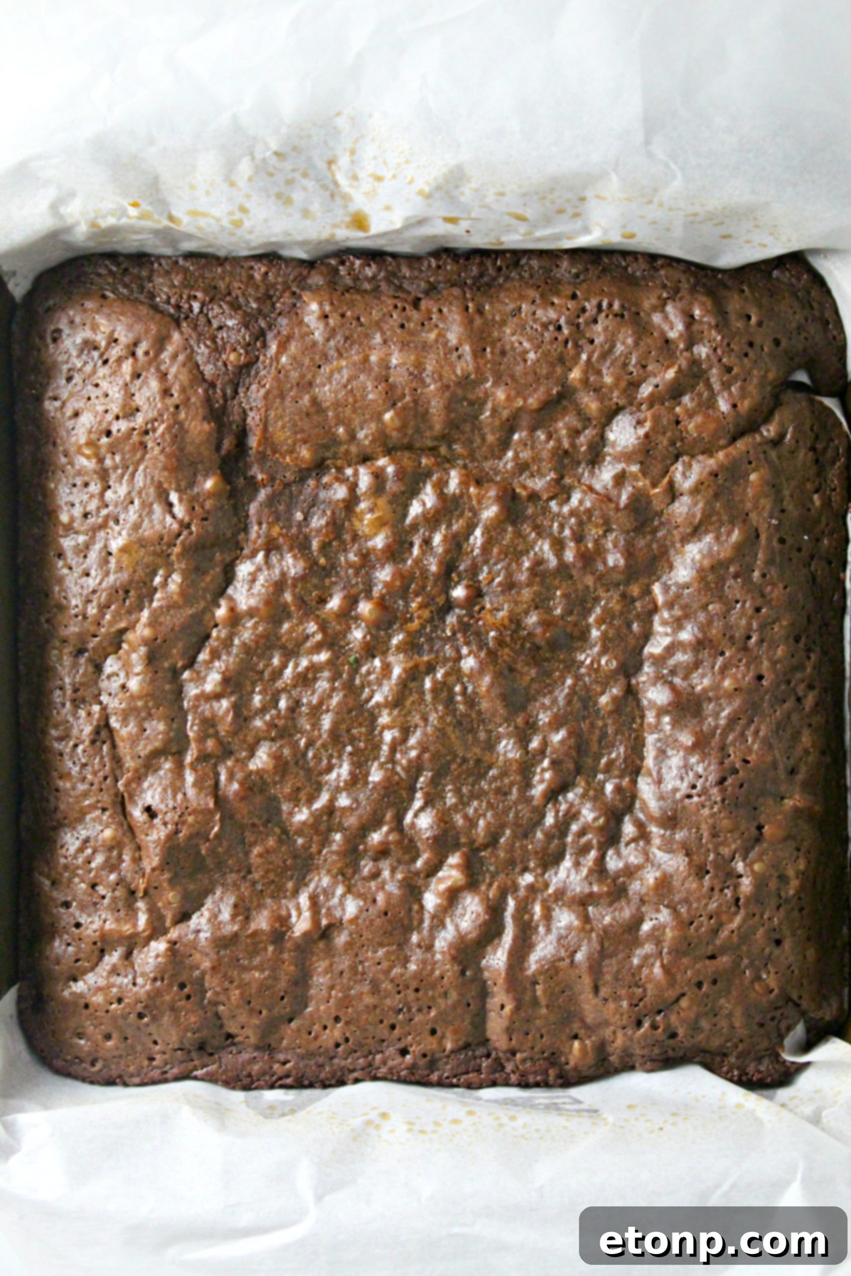 Decadent Dr Pepper Brownies 4 Individual Dr. Pepper brownie squares stacked on a plate, showing their thick, fudgy center