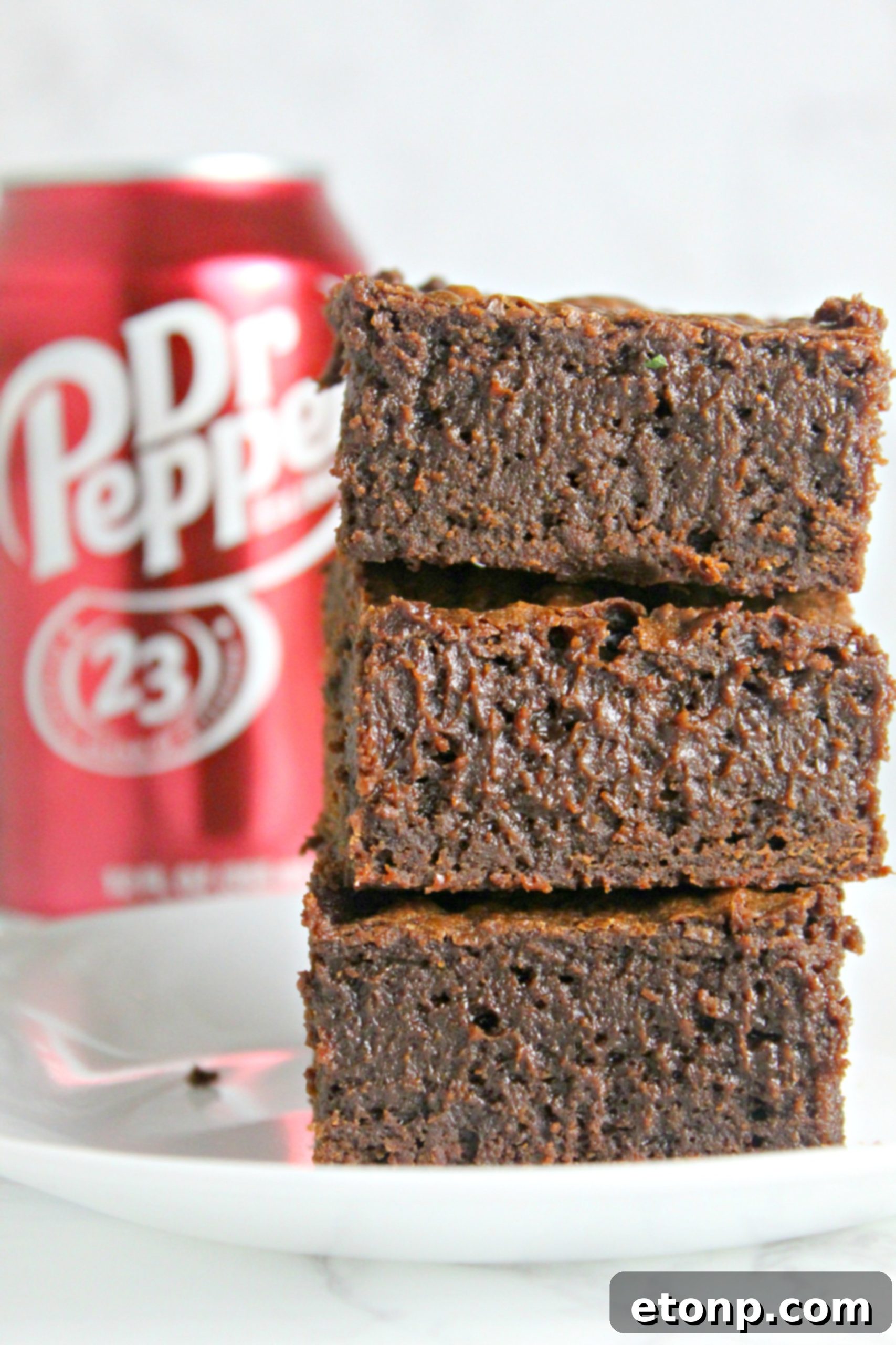 Decadent Dr Pepper Brownies 9 Close-up of frosted Dr. Pepper brownies, cut into squares and ready to serve