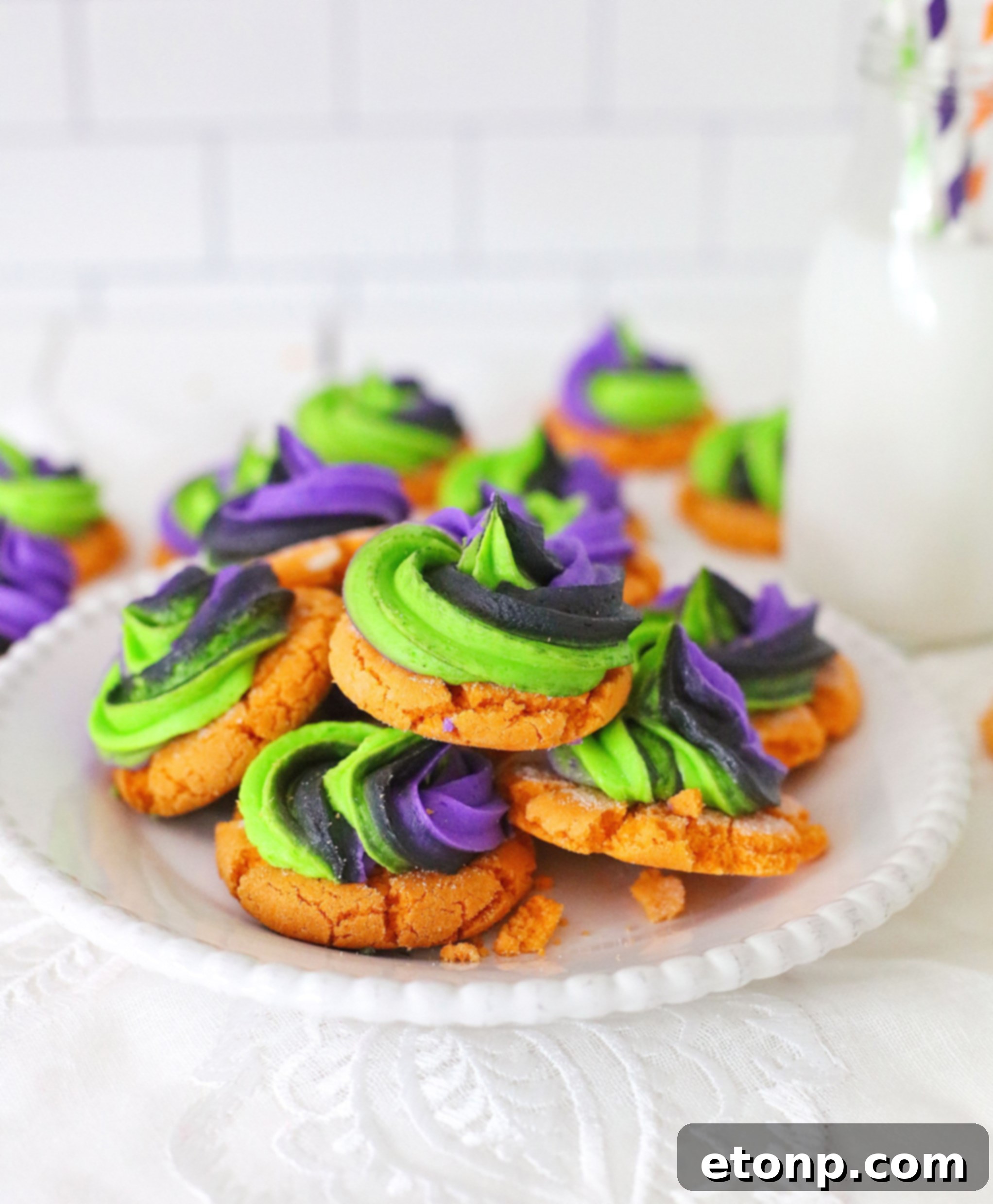 Close-up of a festive pumpkin sugar cookie with vibrant buttercream frosting, perfect for Halloween celebrations.
