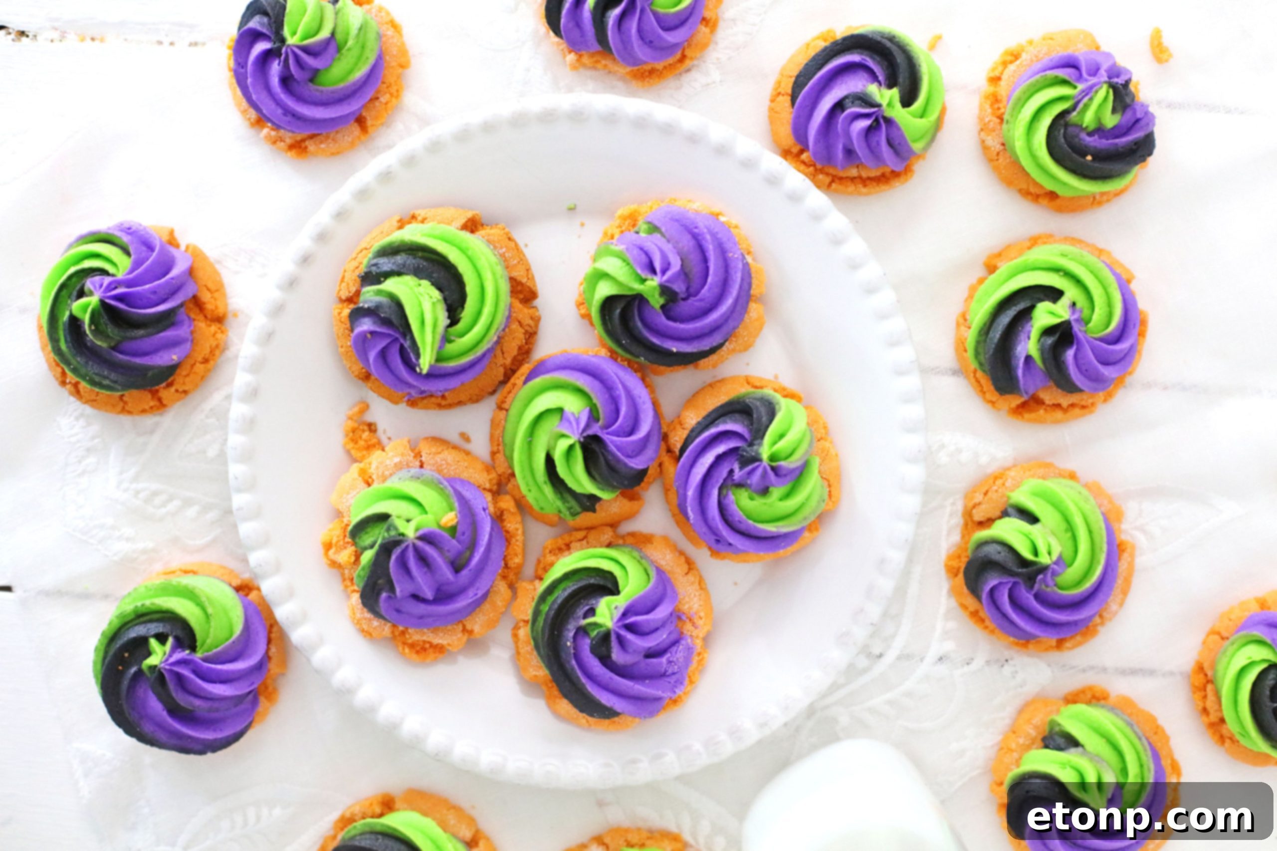 Assorted pumpkin sugar cookies arranged on a platter, showcasing their vibrant colors and festive decorations.