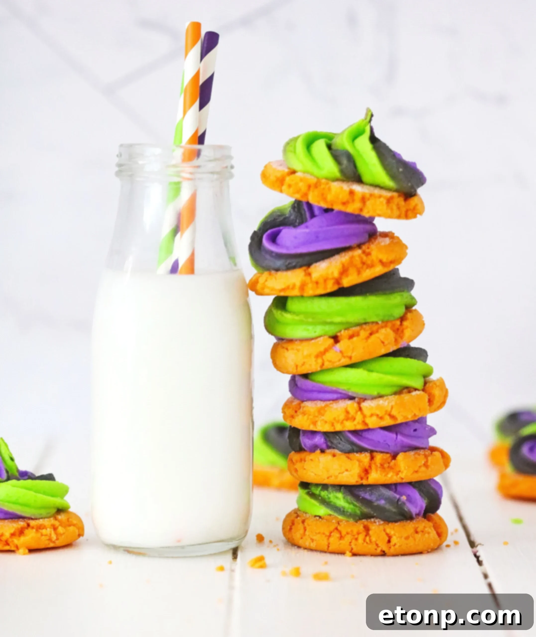 A collection of elaborately decorated pumpkin sugar cookies with various Halloween-themed designs on a white background.
