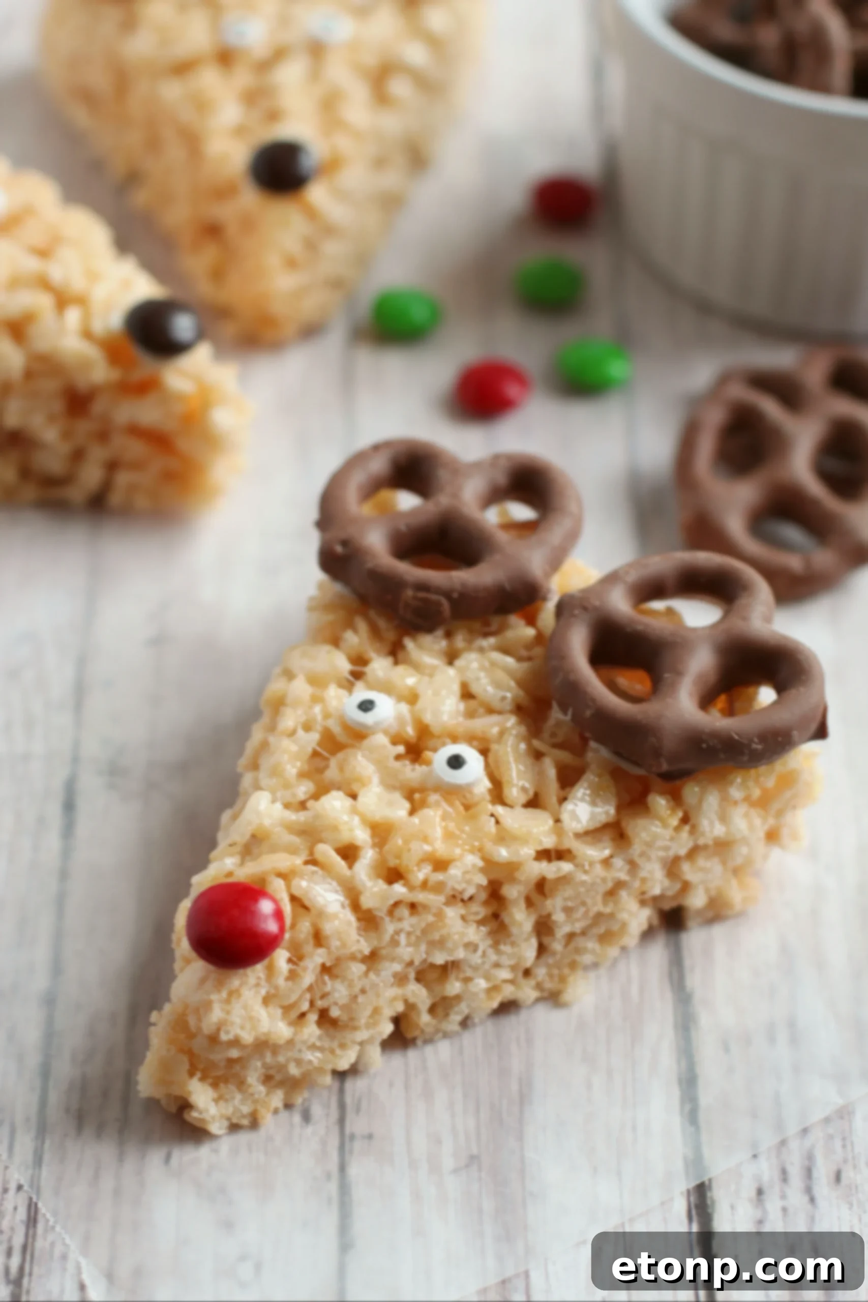 Several Reindeer Rice Krispie Treats arranged on a platter, ready for a holiday gathering.