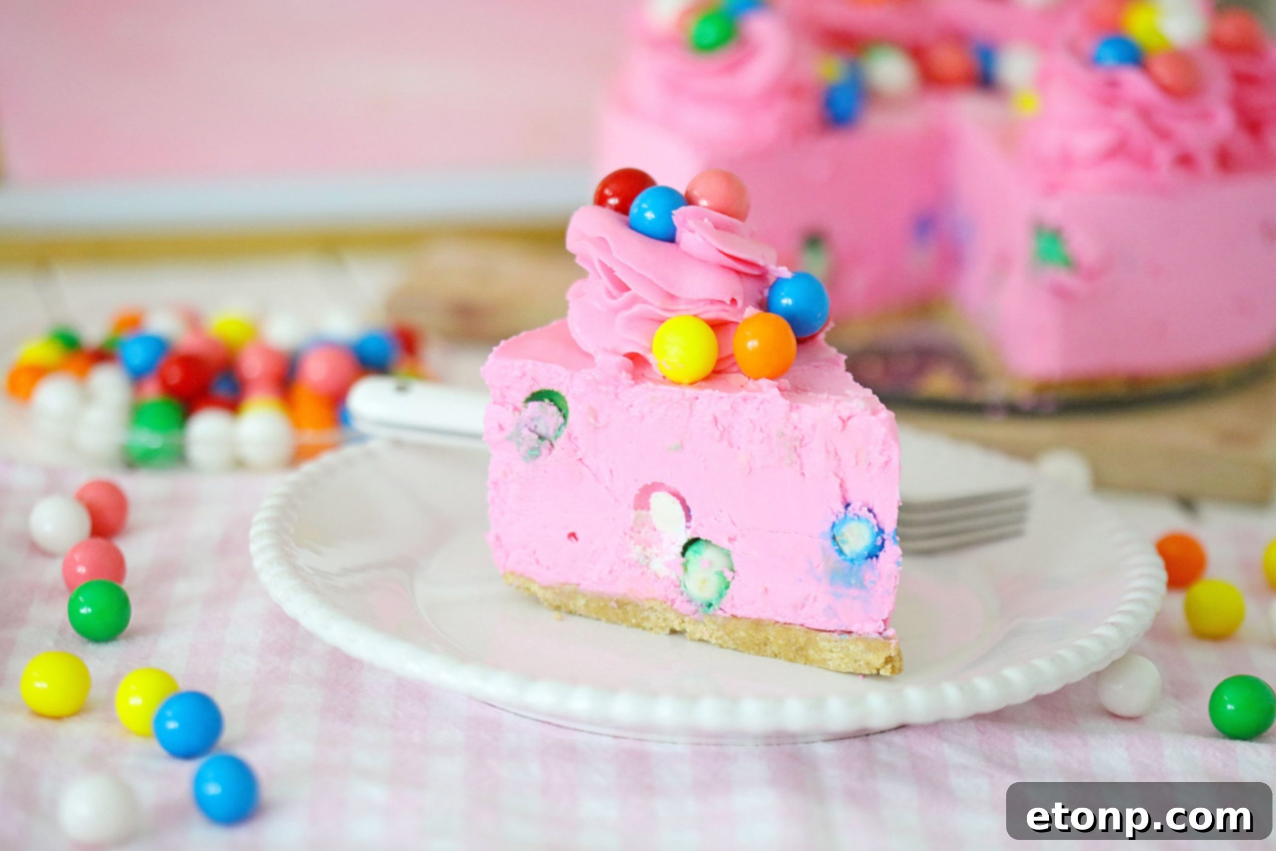 Various vibrant cheesecakes arranged on a table, showcasing different colors and toppings.