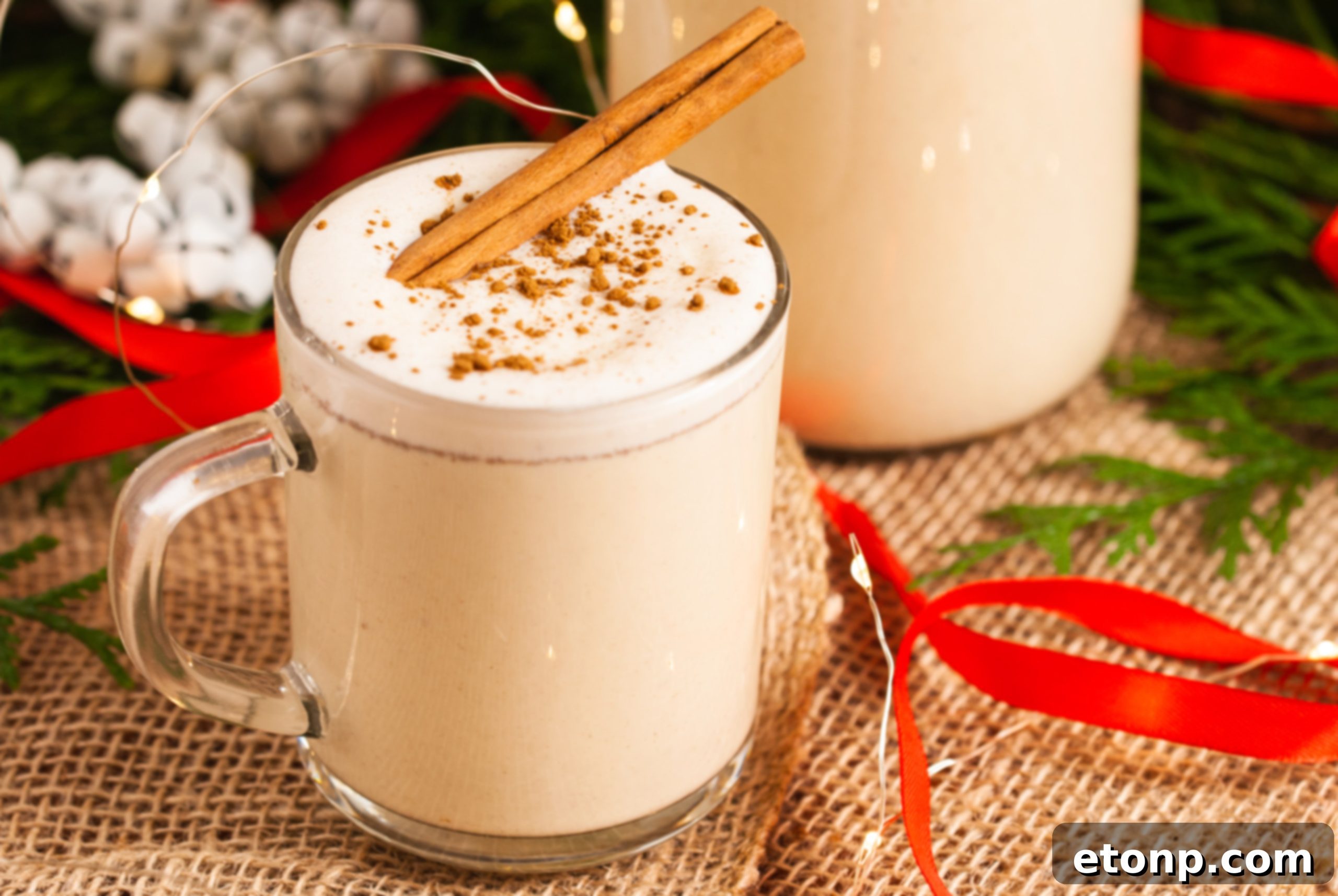 A festive spread with a bowl of eggnog, glasses, and holiday decorations, inviting guests to serve themselves.