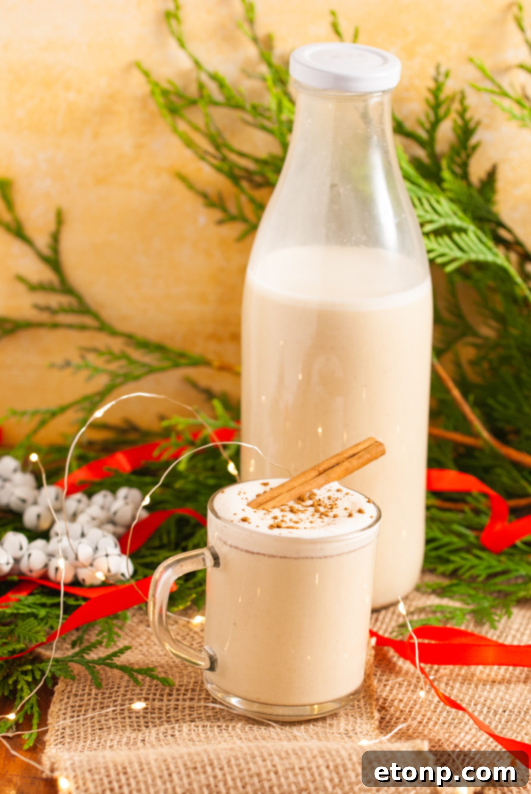 A close-up shot of eggnog ingredients, including fresh eggs, milk, cream, and spices, laid out on a table.