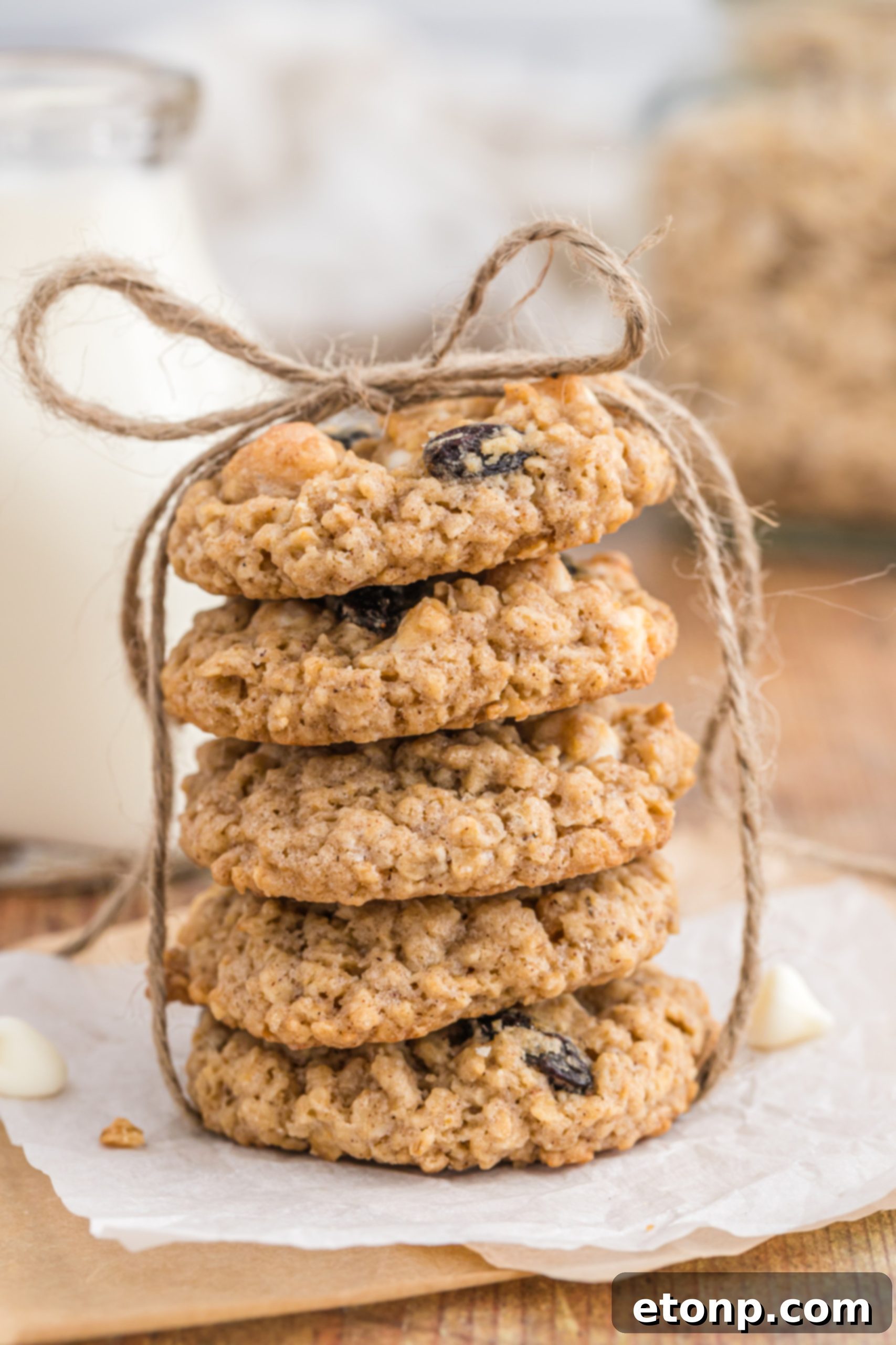 Chewy Oatmeal Raisin Cookies 4 A close-up view of oatmeal raisin cookies cooling, showing their golden-brown edges.