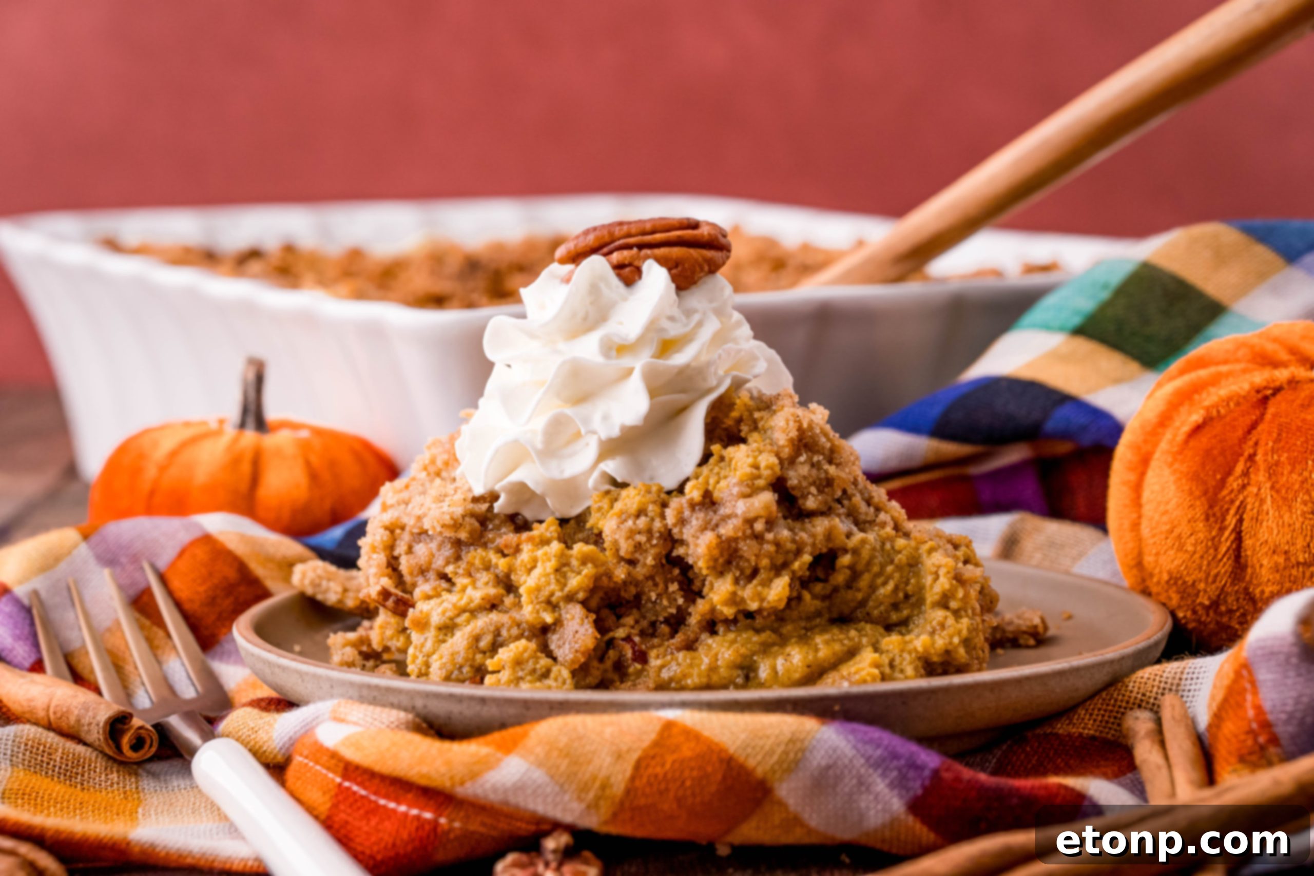 The Pumpkin Pie Crisp in a baking dish on a kitchen counter, ready to be served.