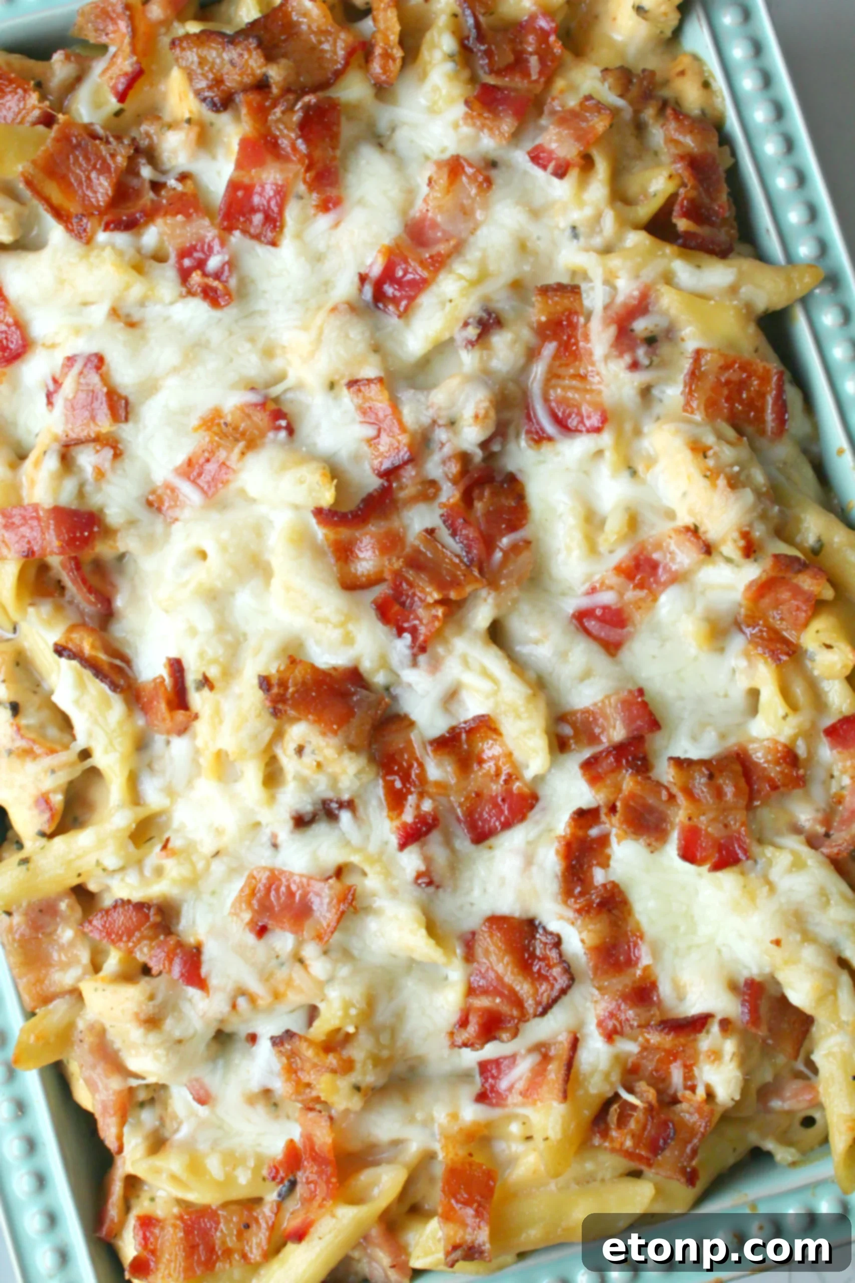 Ultimate Chicken Bacon Ranch Penne 4 A serving of Chicken Bacon Ranch Penne Casserole in a bowl, with steam gently rising, highlighting its freshness.