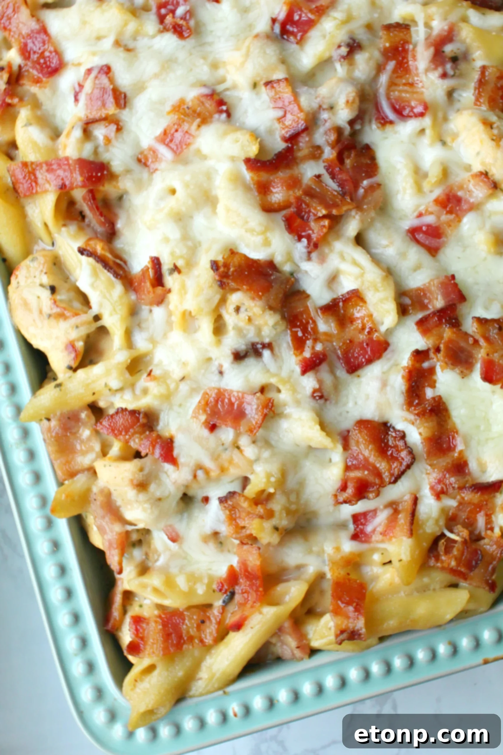 Ultimate Chicken Bacon Ranch Penne 10 A wide shot of the finished Chicken Bacon Ranch Penne Casserole, golden and bubbly, with fresh parsley garnish.