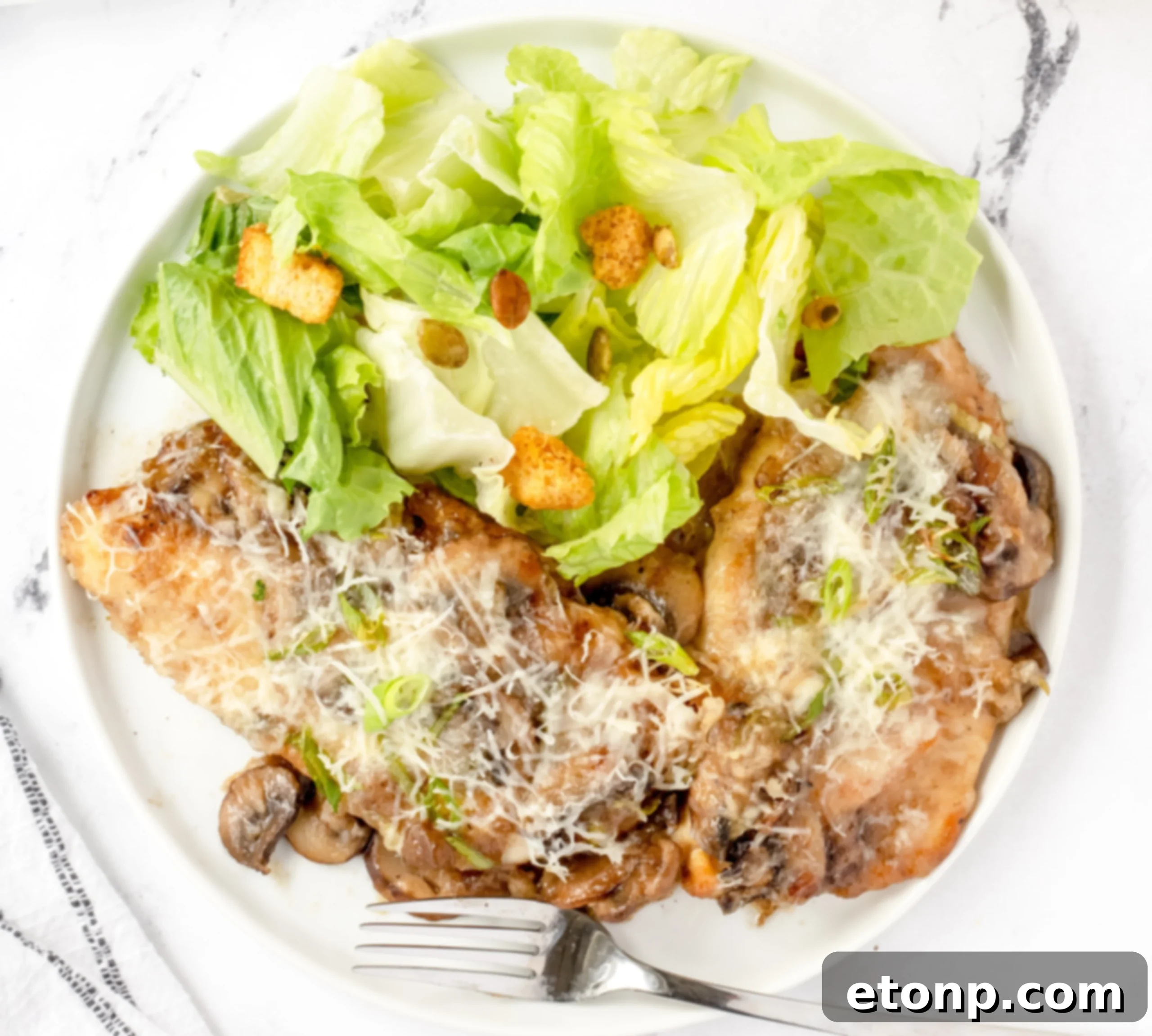 A stack of golden-brown chicken cutlets, perfectly seared, ready to be covered in the creamy Marsala mushroom sauce for Chicken Lombardy.
