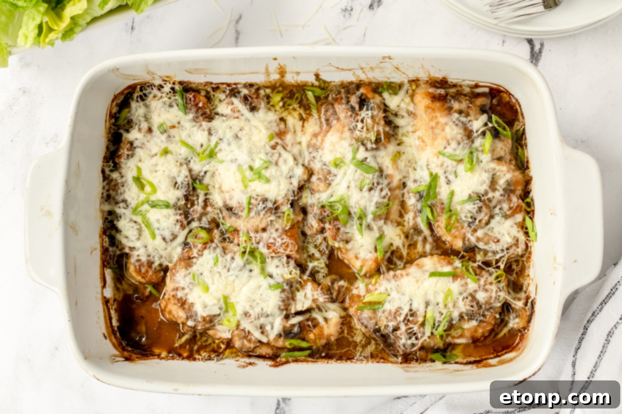 A spoonful of the creamy, rich Marsala mushroom sauce, with visible pieces of sautéed mushrooms, highlighting the luxurious texture and appealing color of the sauce.