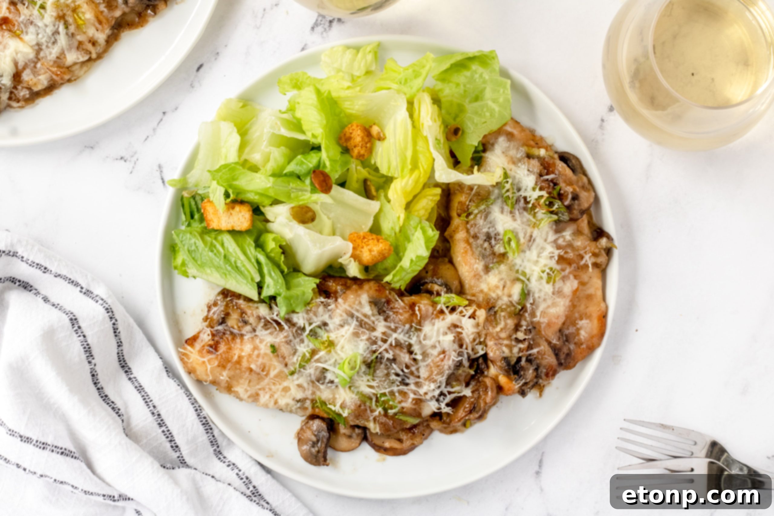 A single serving of Chicken Lombardy on a white plate, showcasing the tenderness of the chicken and the rich, creamy sauce, with a fork ready to enjoy.