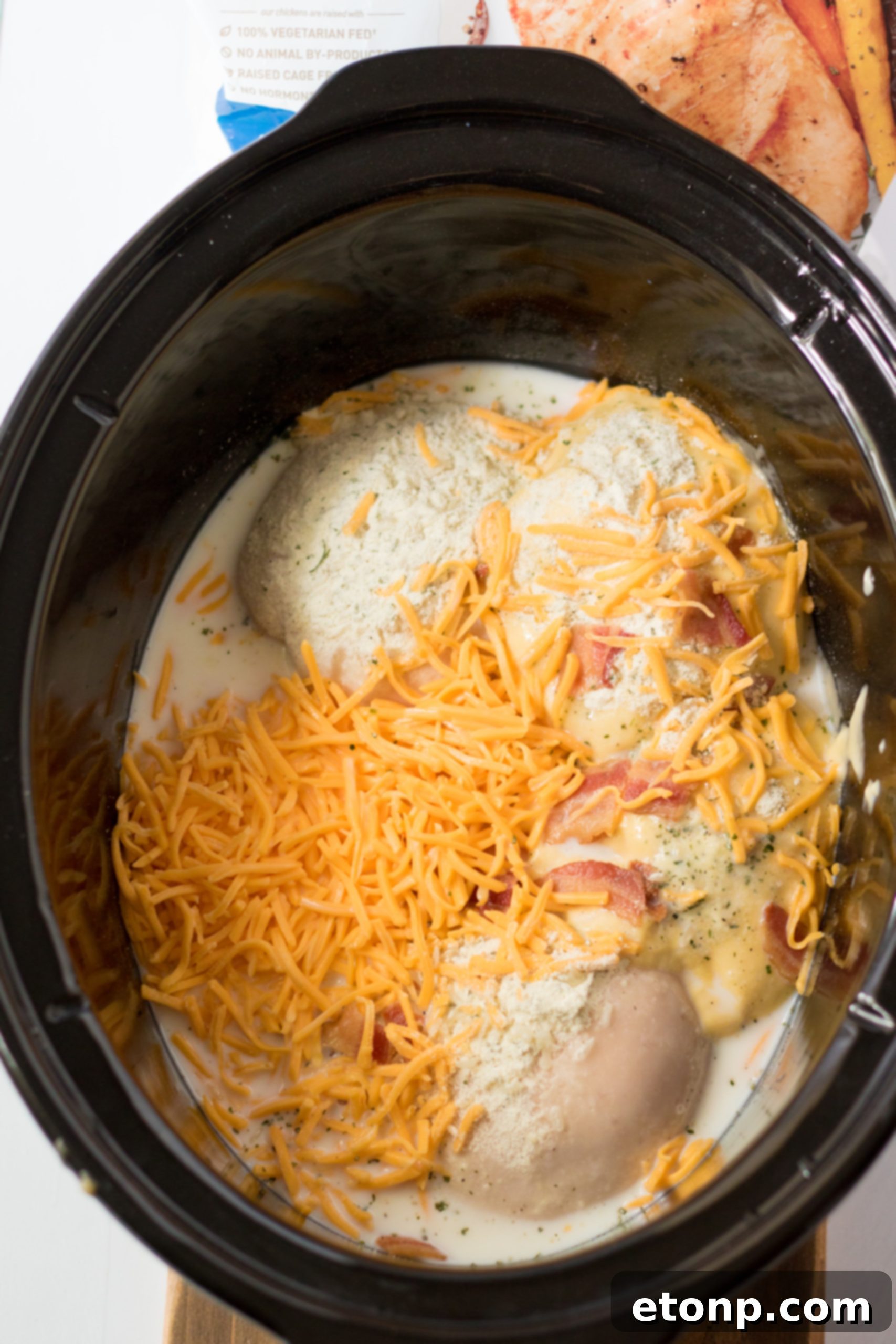 Slow Cooker Cheesy Crack Chicken and Rice being stirred