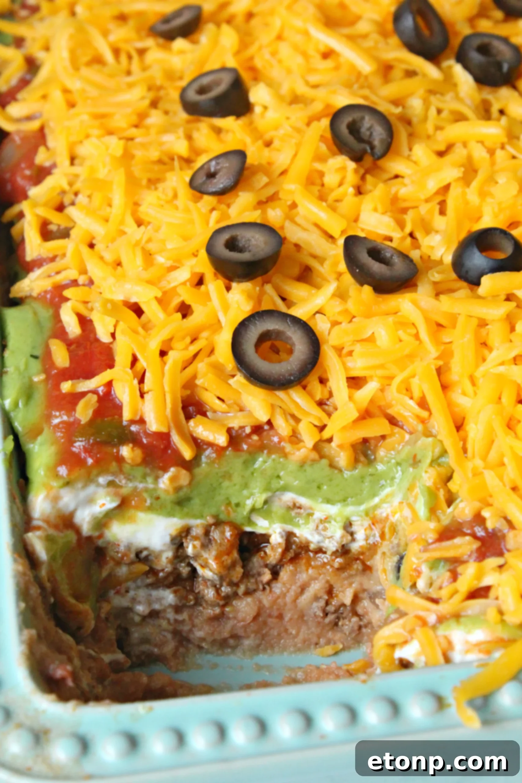 7 layer taco dip topped with cheese and olives