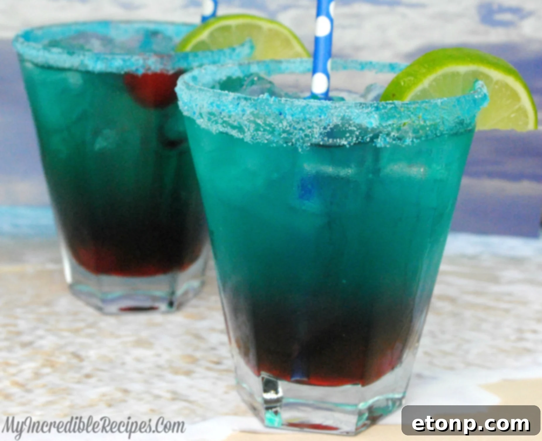 The Shark Bite cocktail, a vibrant blue-green drink with red grenadine 'blood' drops, ready to be served at a party.