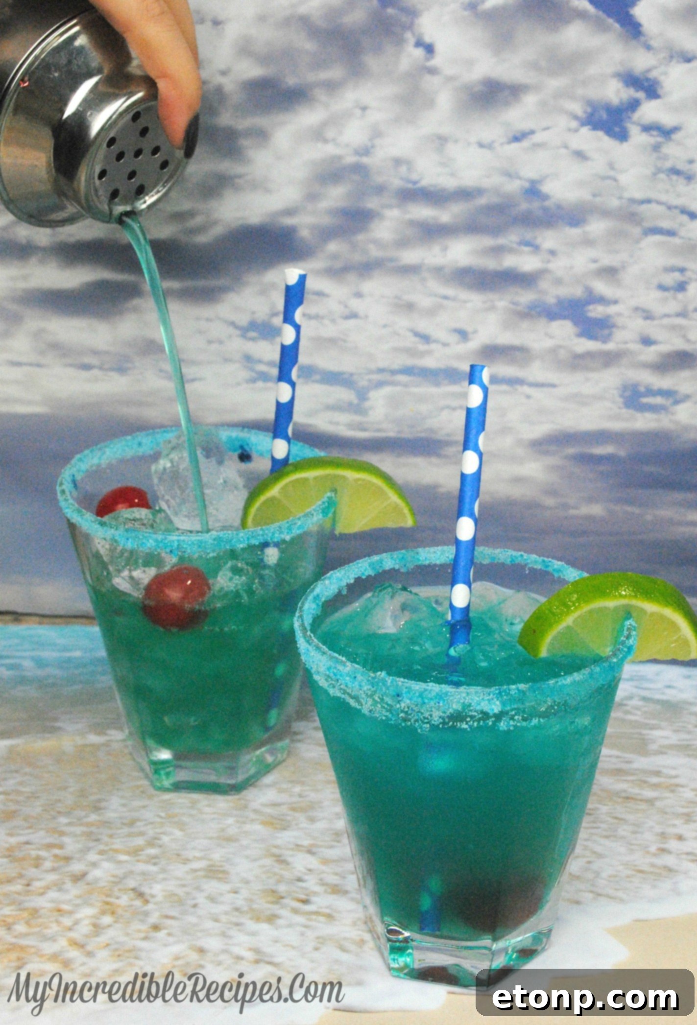 The ingredients for a Shark Bite cocktail laid out: Malibu rum, Blue Curacao, pineapple juice, Sprite, lime juice, grenadine, and a cherry garnish.
