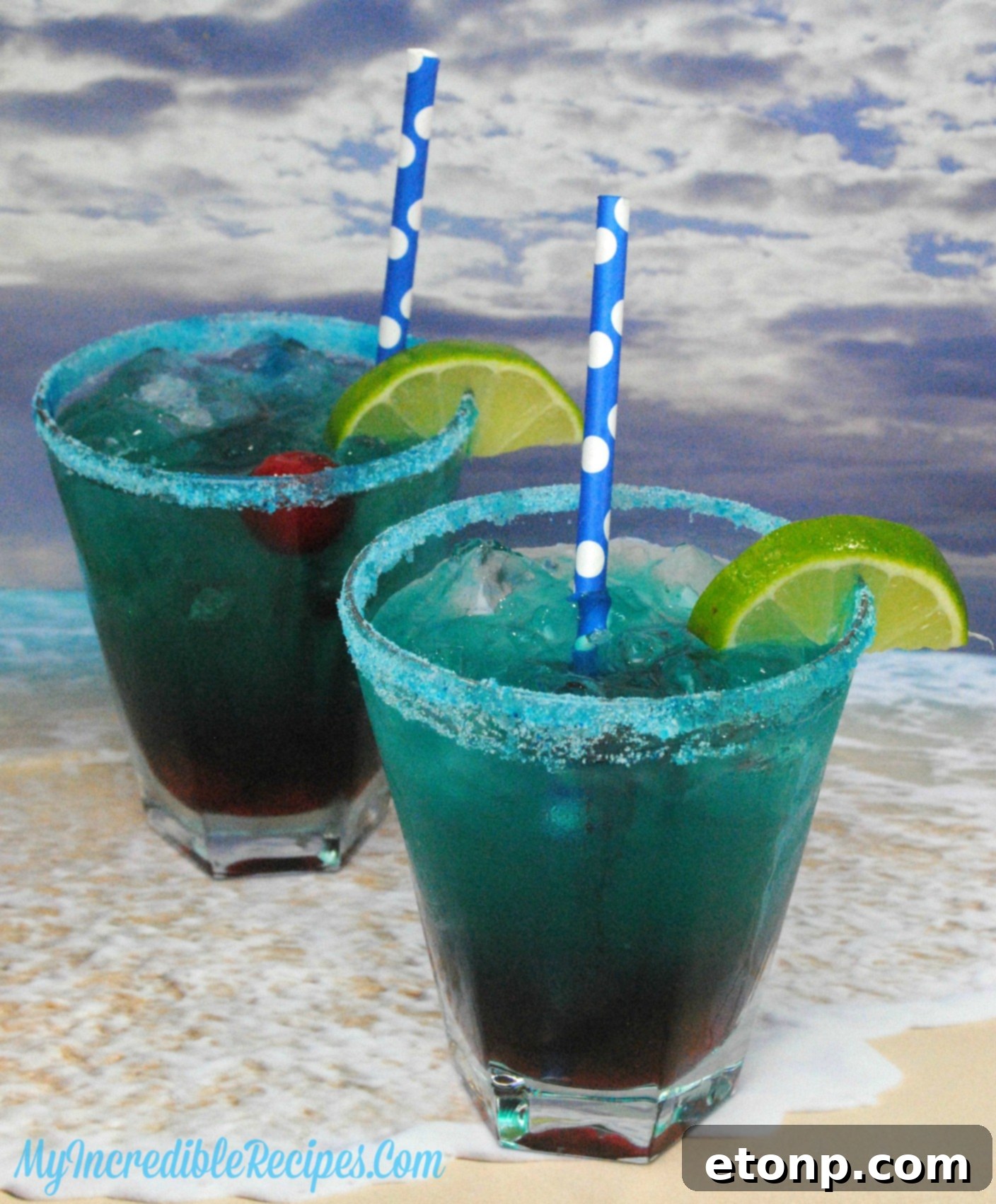 A hand holding a Shark Bite cocktail, showing the beautiful presentation and inviting look of the drink.