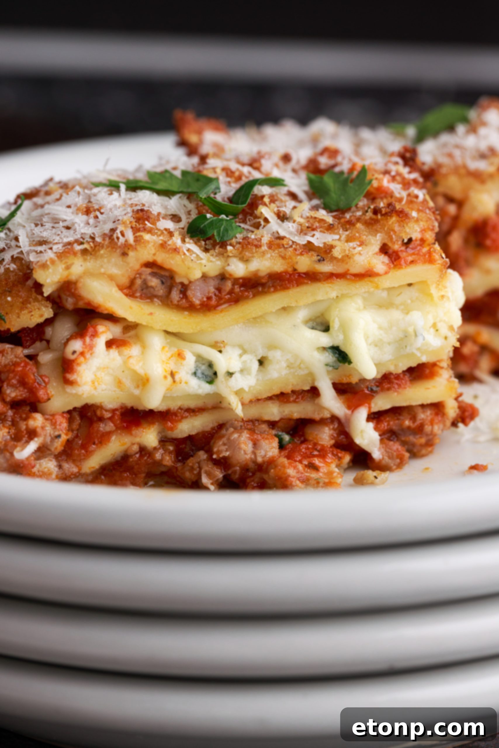 A stack of deep fried lasagna pieces, showcasing their crispy edges