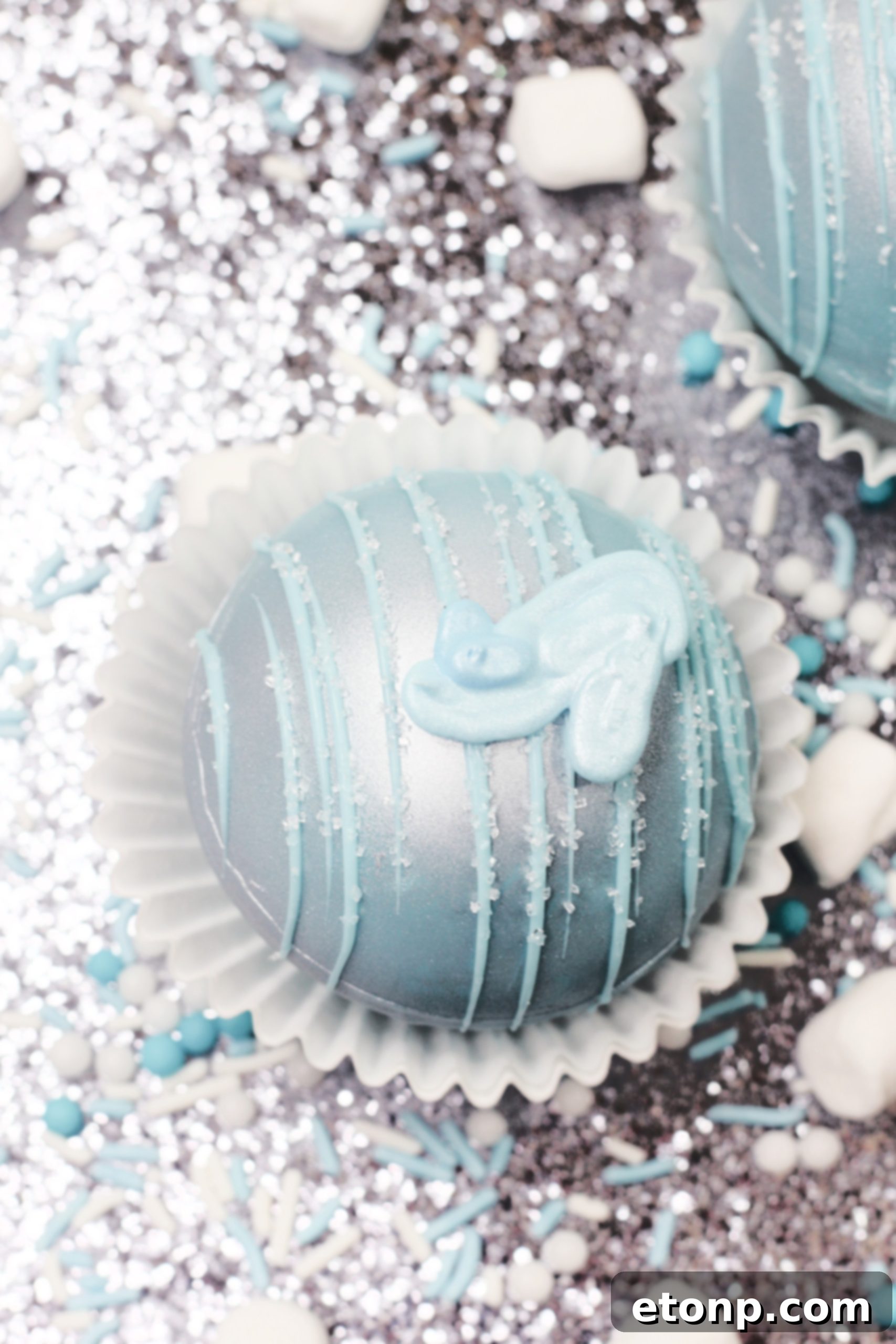 A steaming mug of hot chocolate made from a Cinderella Hot Cocoa Bomb, with melted blue chocolate and marshmallows floating on top, ready to be enjoyed.