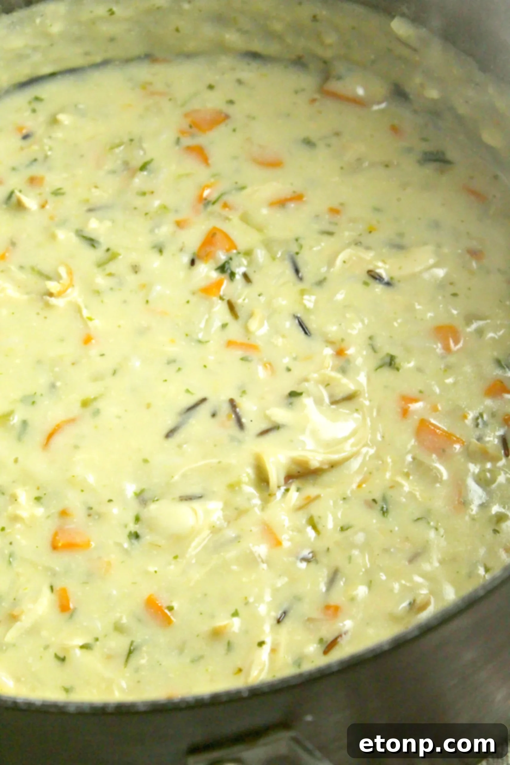 The Copycat Panera Chicken & Wild Rice Soup served in a rustic bread bowl, a perfect accompaniment.