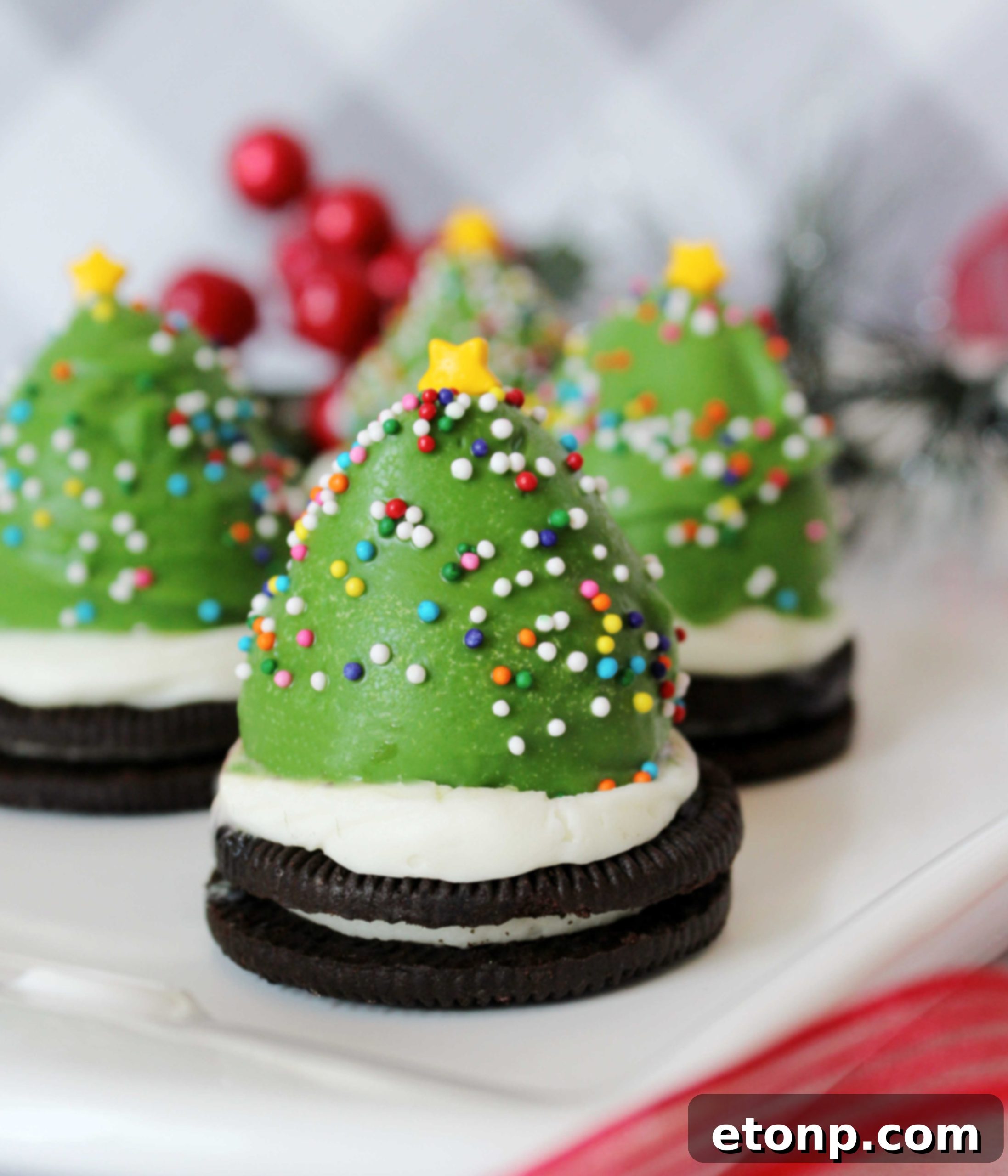 Assortment of holiday treats including Chocolate Covered Strawberry Christmas Trees on a festive tray