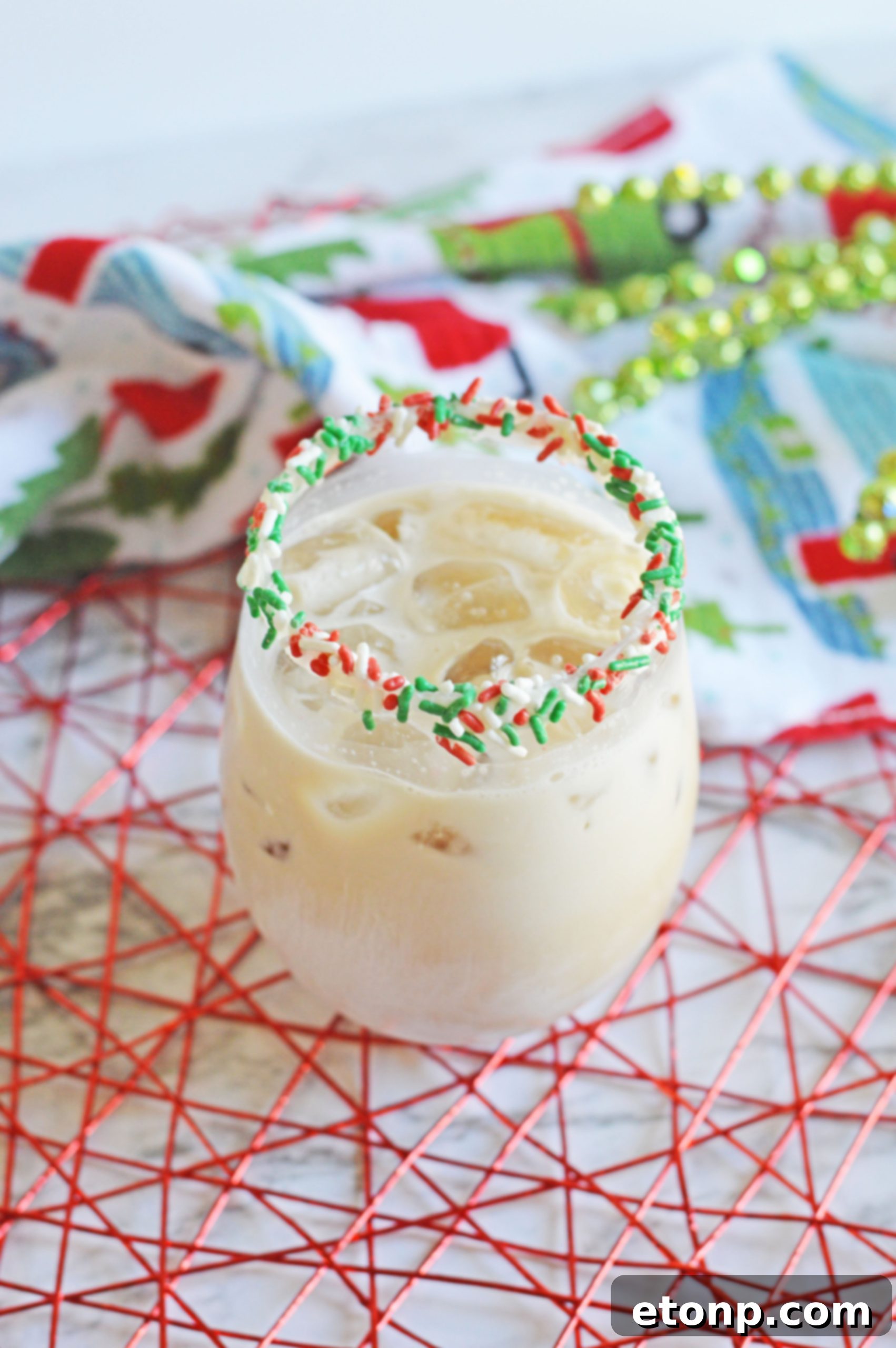 Close-up of a Christmas Cookie Cocktail with a decorative sugar cookie. 