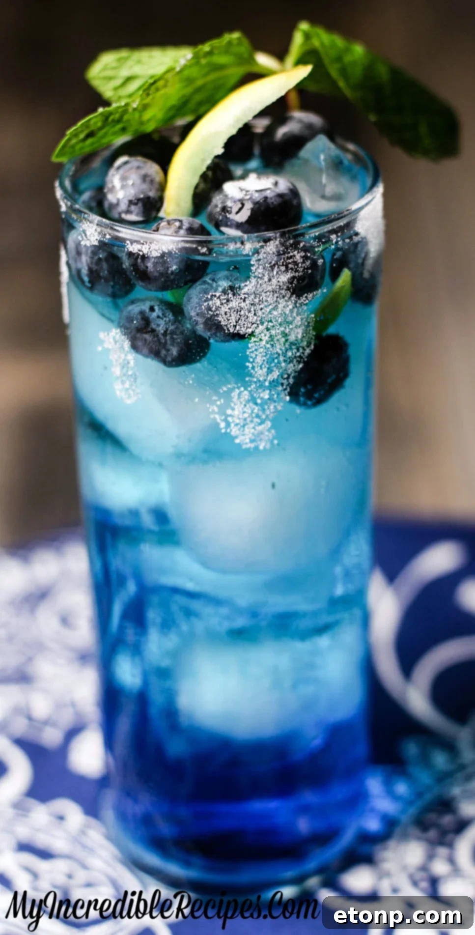 Zingy Blueberry Lemonade 6 Artistic close-up of the Bangin' Blueberry Lemonade in a unique glass, showing the effervescence and garnishes