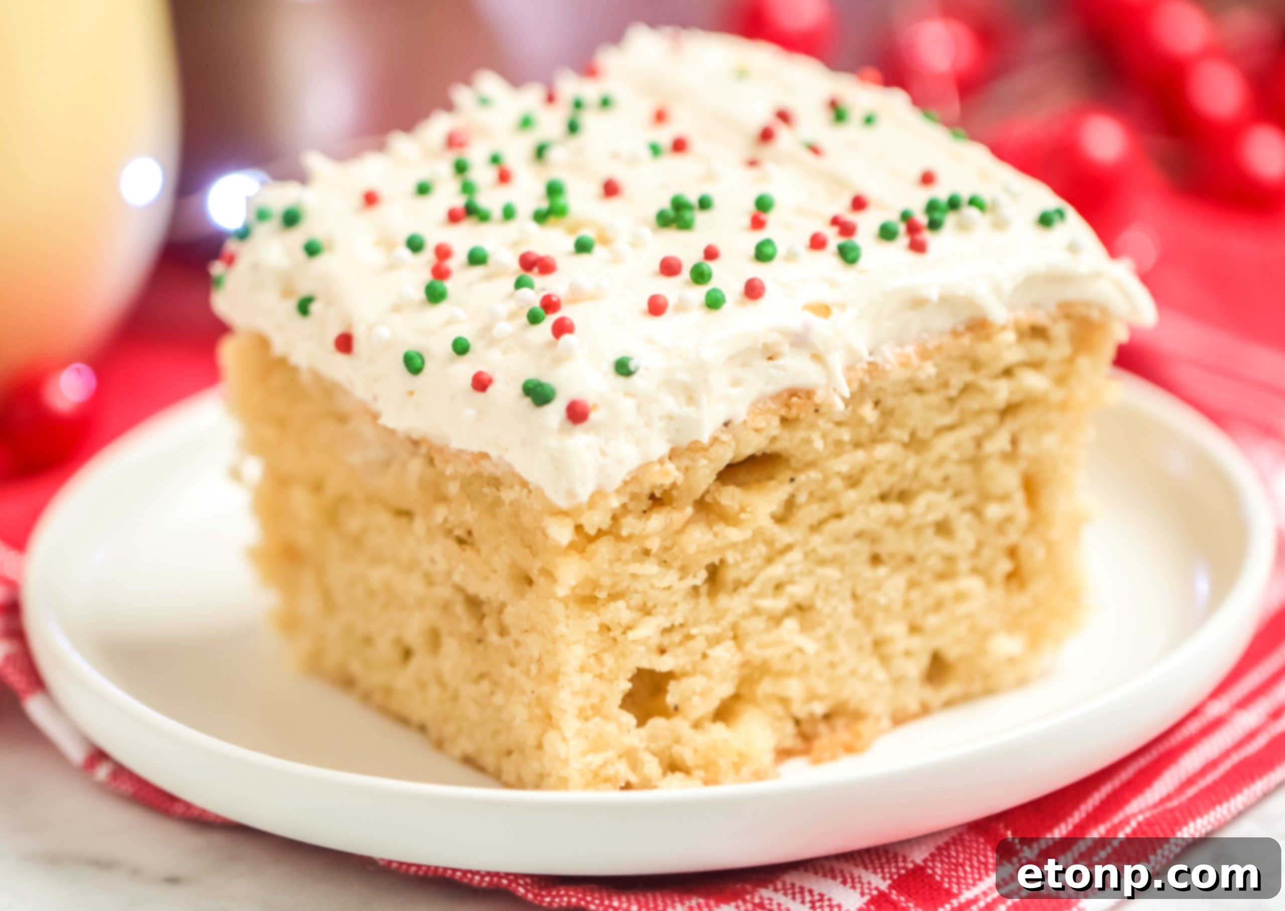 Holiday Eggnog Sheet Cake Delight 2 Delicious slice of Eggnog Sheet Cake with creamy frosting, ready to be enjoyed during the holidays.