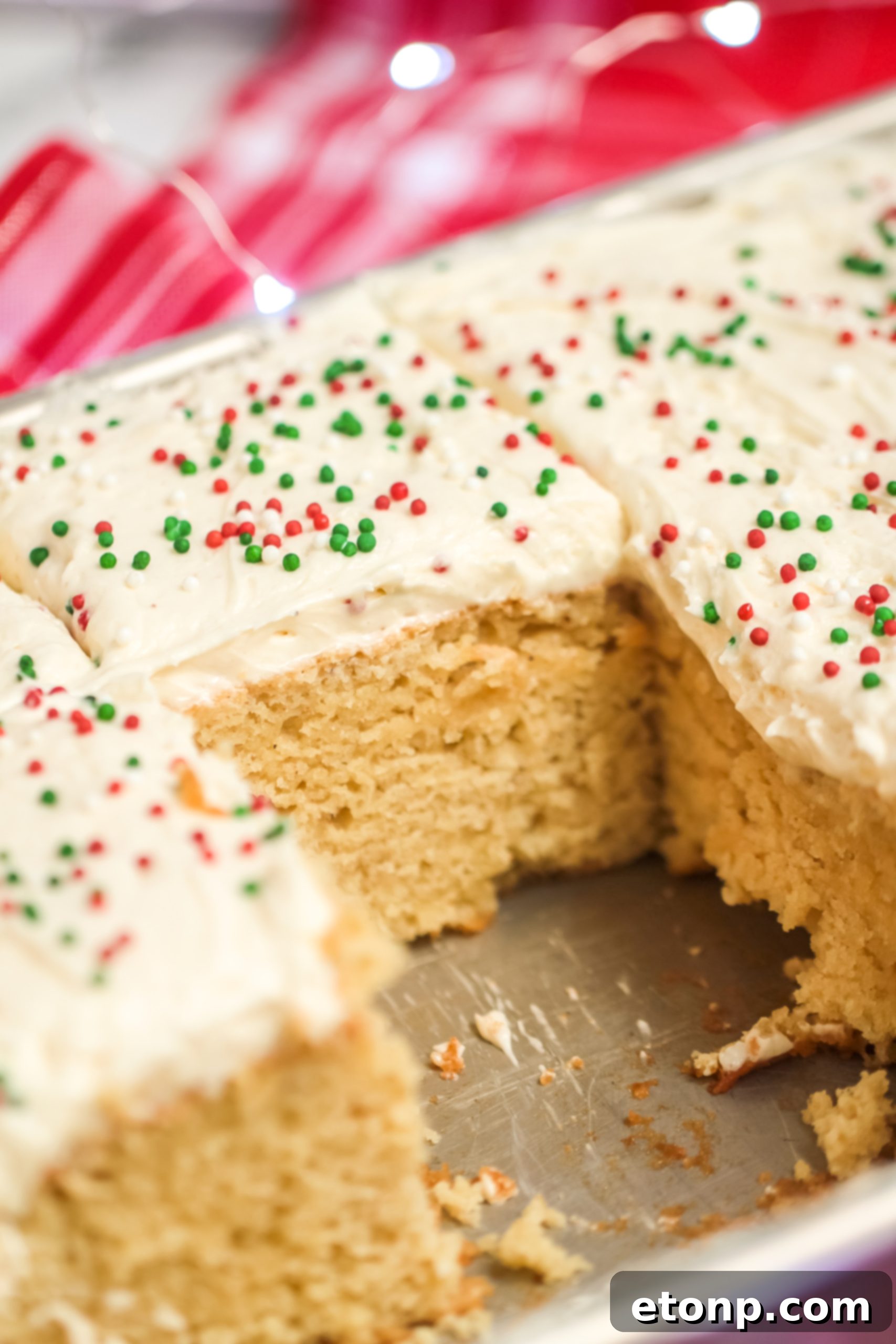 Holiday Eggnog Sheet Cake Delight 6 A large slice of Eggnog Sheet Cake presented on a white plate, highlighting the rich frosting and festive appeal.