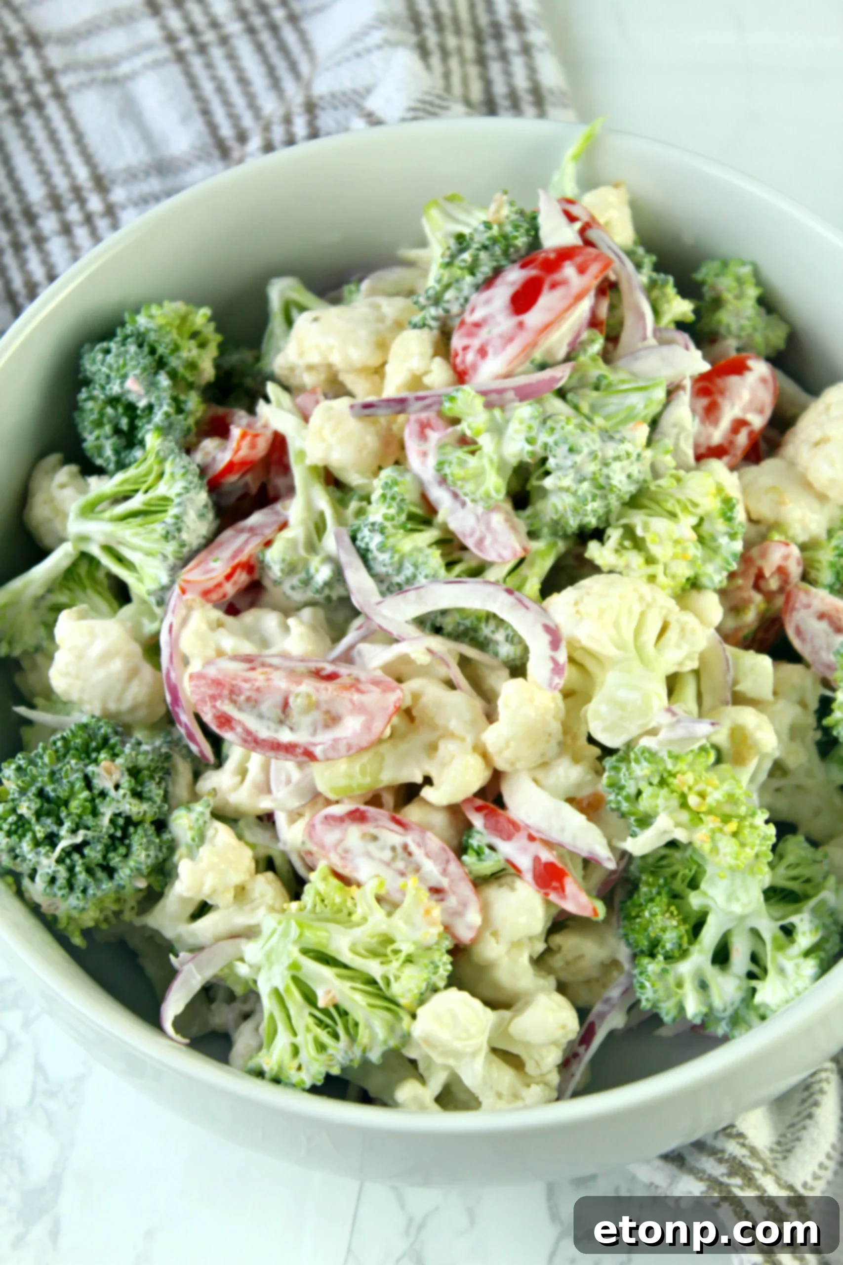 A vibrant Christmas Salad with a creamy dressing, served in a decorative bowl, highlighting its crunchy textures and festive colors.