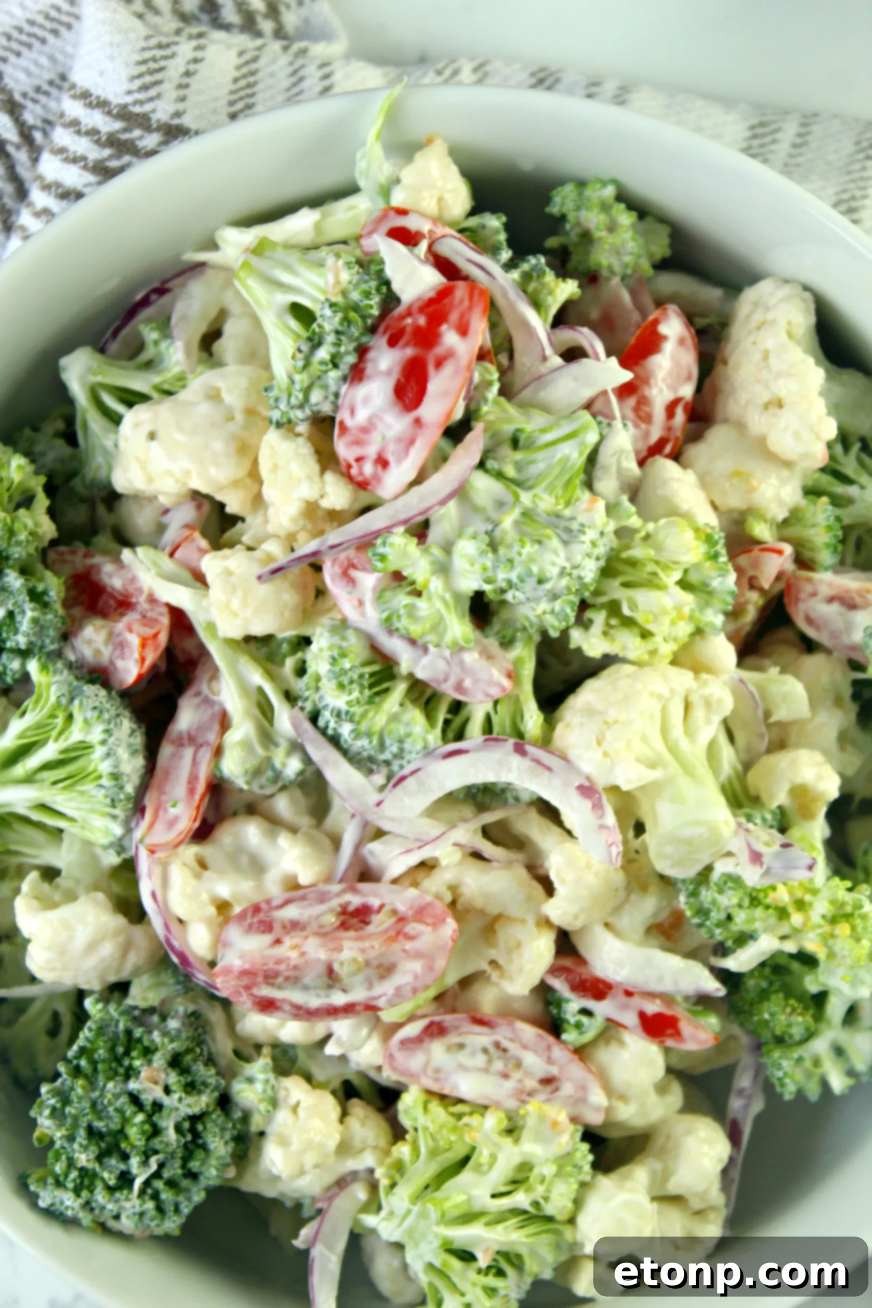 A spoonful of granulated sugar, highlighting its role in balancing the flavors of the Christmas Salad dressing.