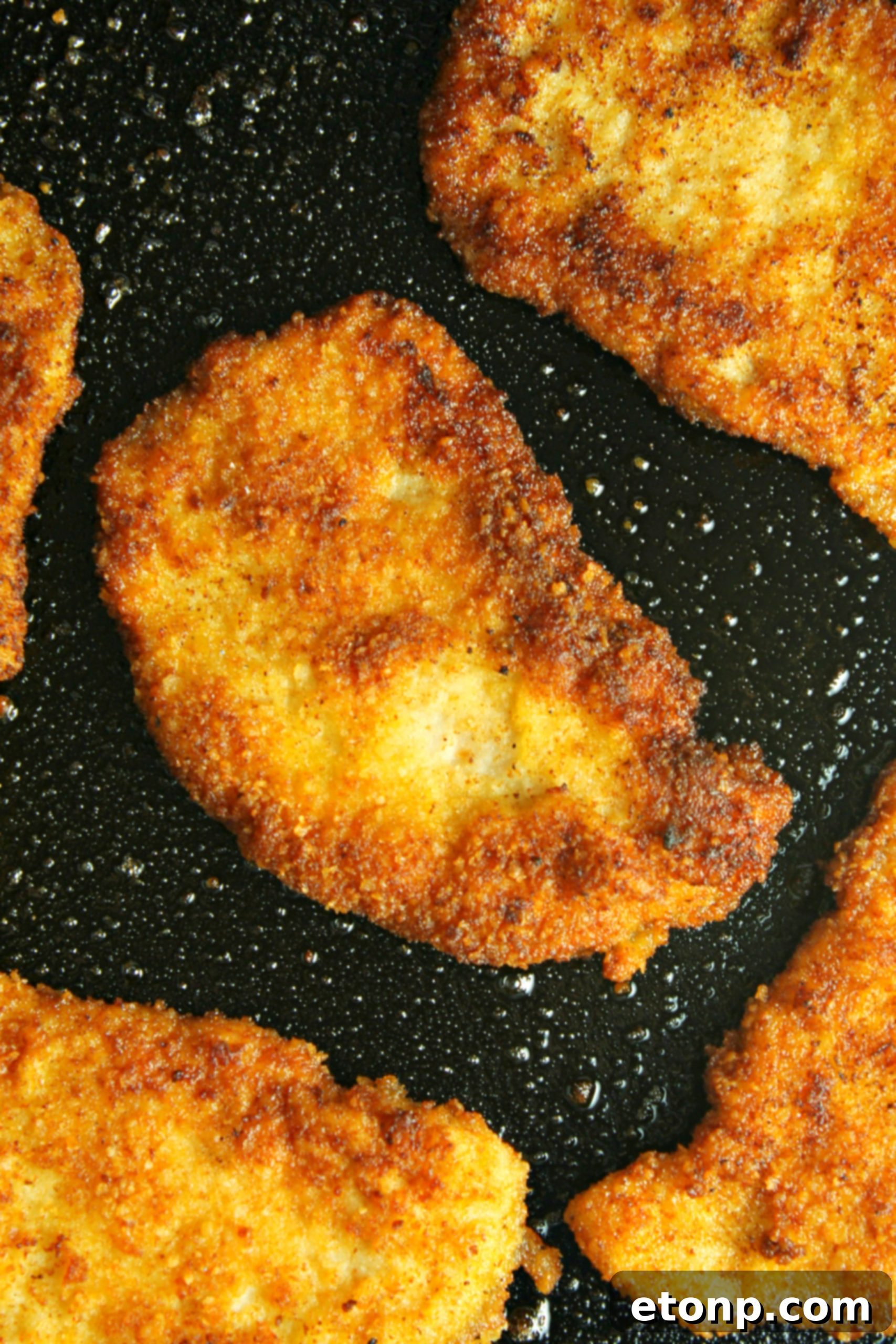 Deliciously crispy Pork Schnitzel served on a plate with fresh lemon