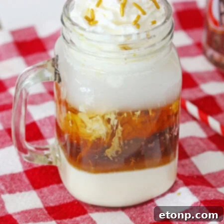 Decadent Layered Root Beer Float Cocktail 8 A stunning Layered Root Beer Float Cocktail topped with whipped cream and sprinkles.