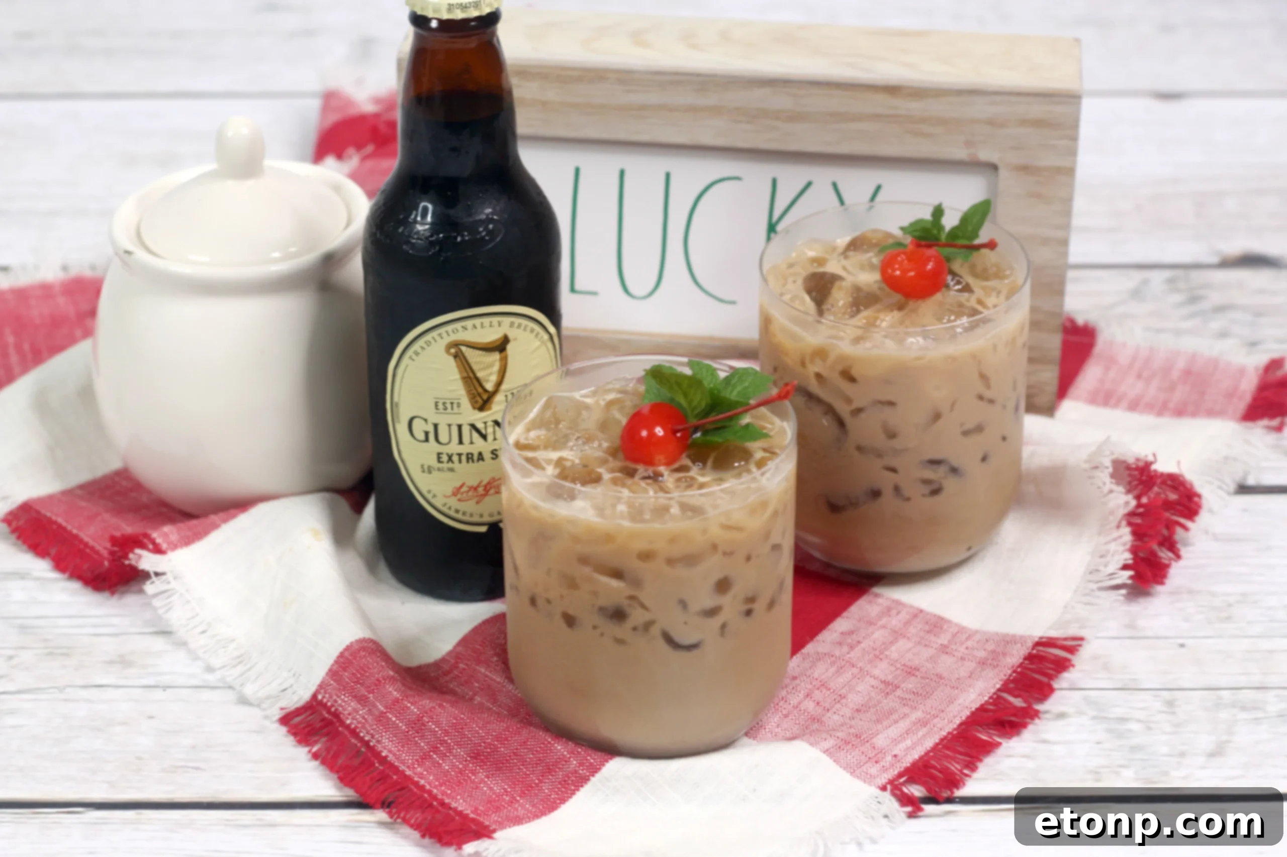 Two glasses of Baileys Irish Cream McGregor Cocktail on a wooden surface, ready to be enjoyed at a gathering.