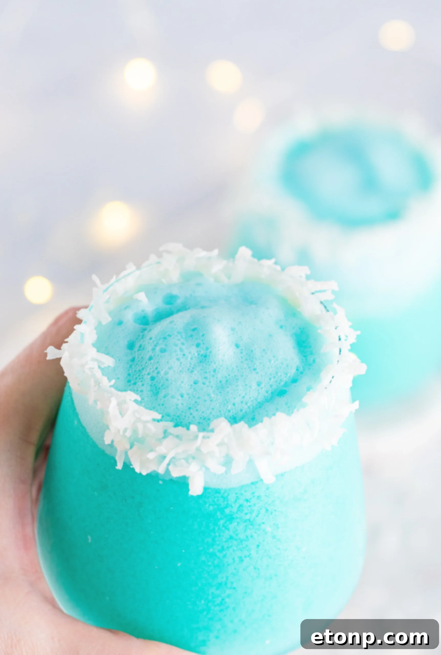 Jack Frost Cocktail with blue hue and coconut rim