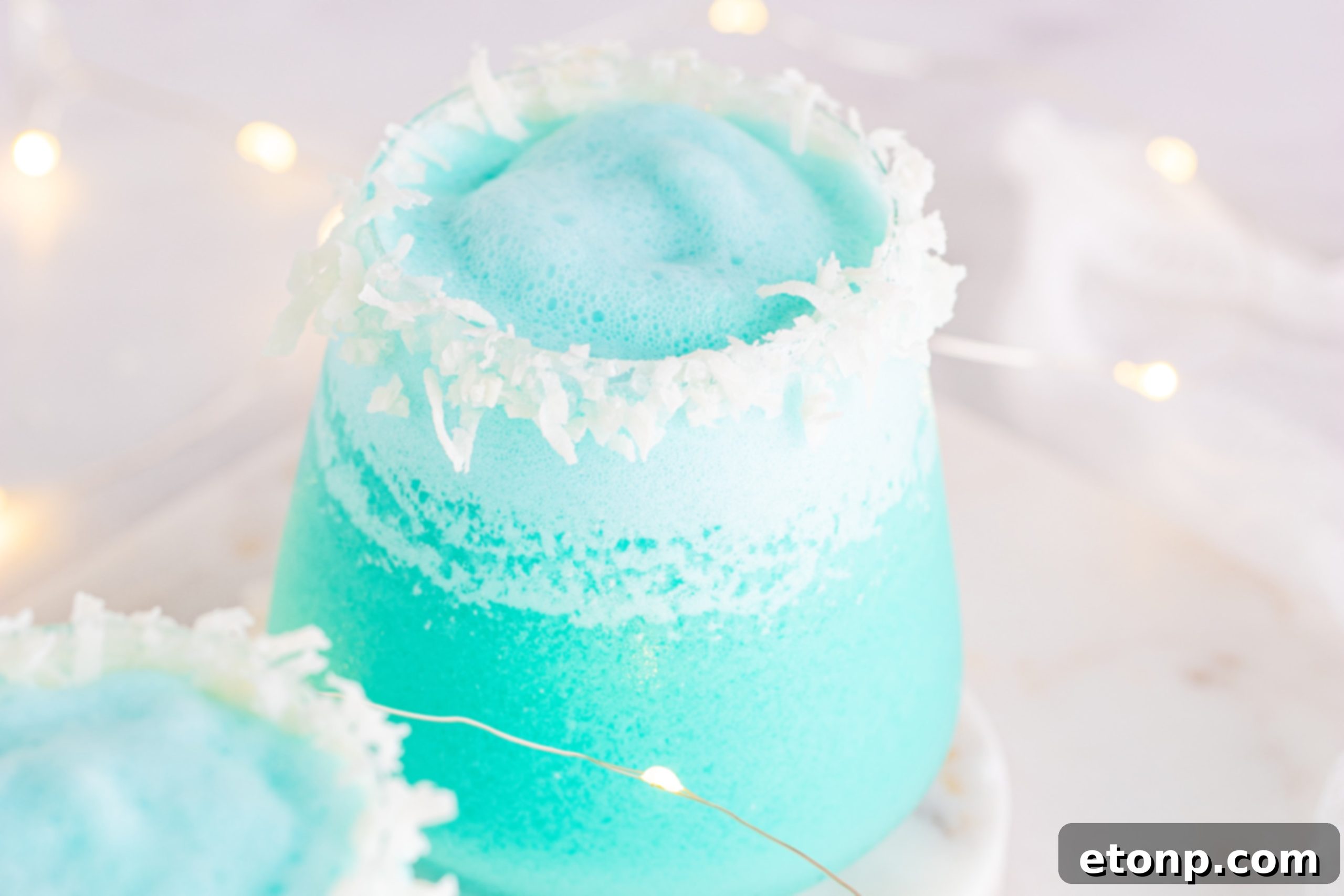 Three Jack Frost Cocktails with festive straws and coconut rims