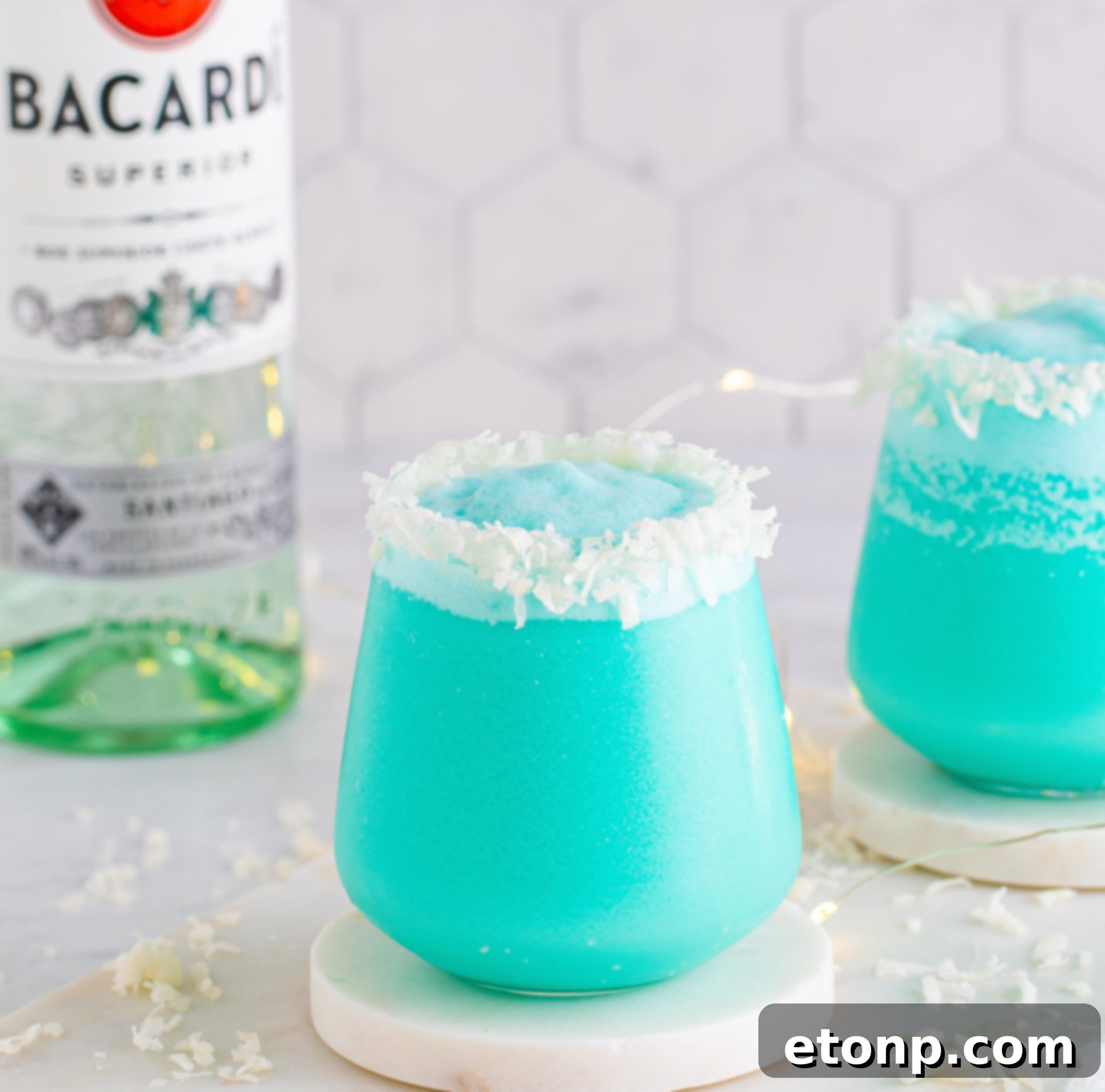 A Jack Frost Cocktail with a festive background, perhaps a holiday party scene