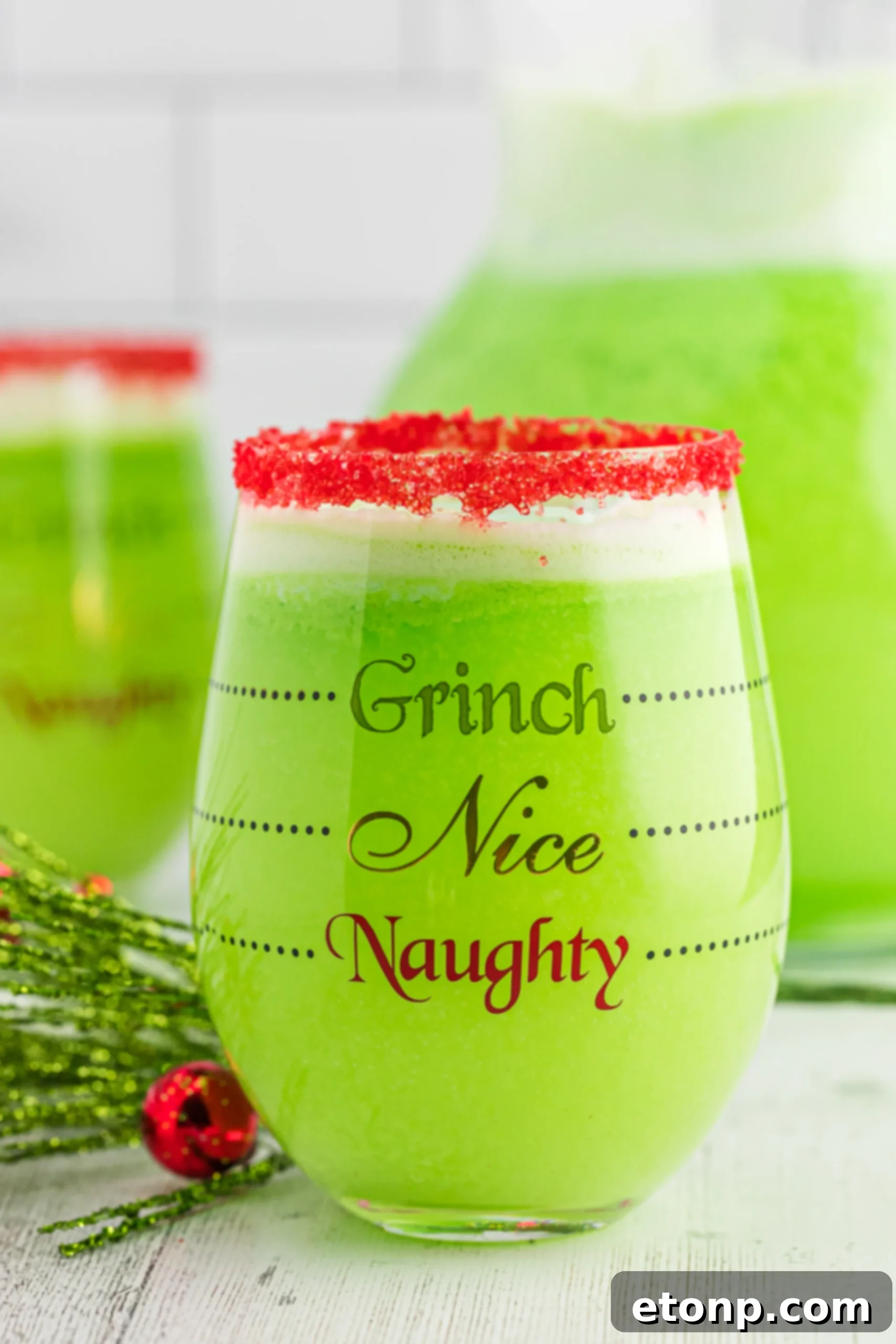 The Grinch's Heart-Growing Holiday Brew 4 A large punch bowl filled with green Grinch Punch and scoops of lime sherbet, ready to be served.