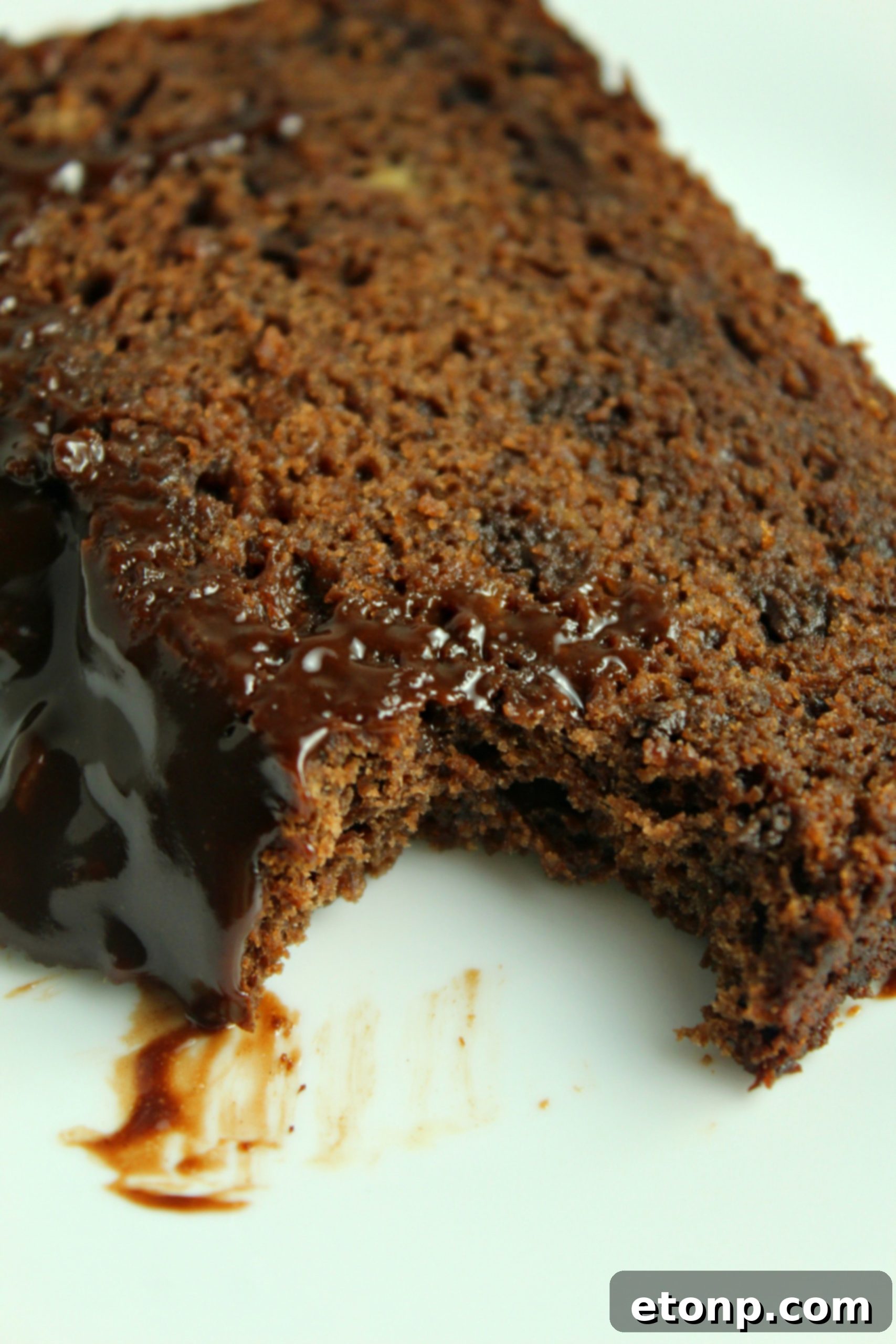 An overhead view of a freshly baked loaf of double chocolate banana bread, cooling on a rack.