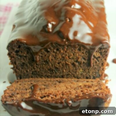 A perfectly baked loaf of Double Chocolate Banana Bread with a generous chocolate glaze.