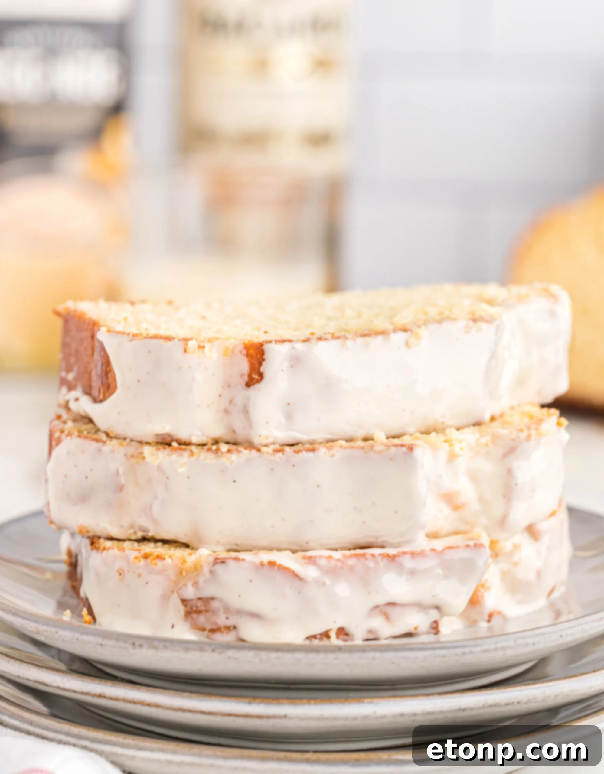 Rum-Drenched Eggnog Loaf 11 Several slices of Boozy Eggnog Bread with Rum Glaze on a festive serving platter