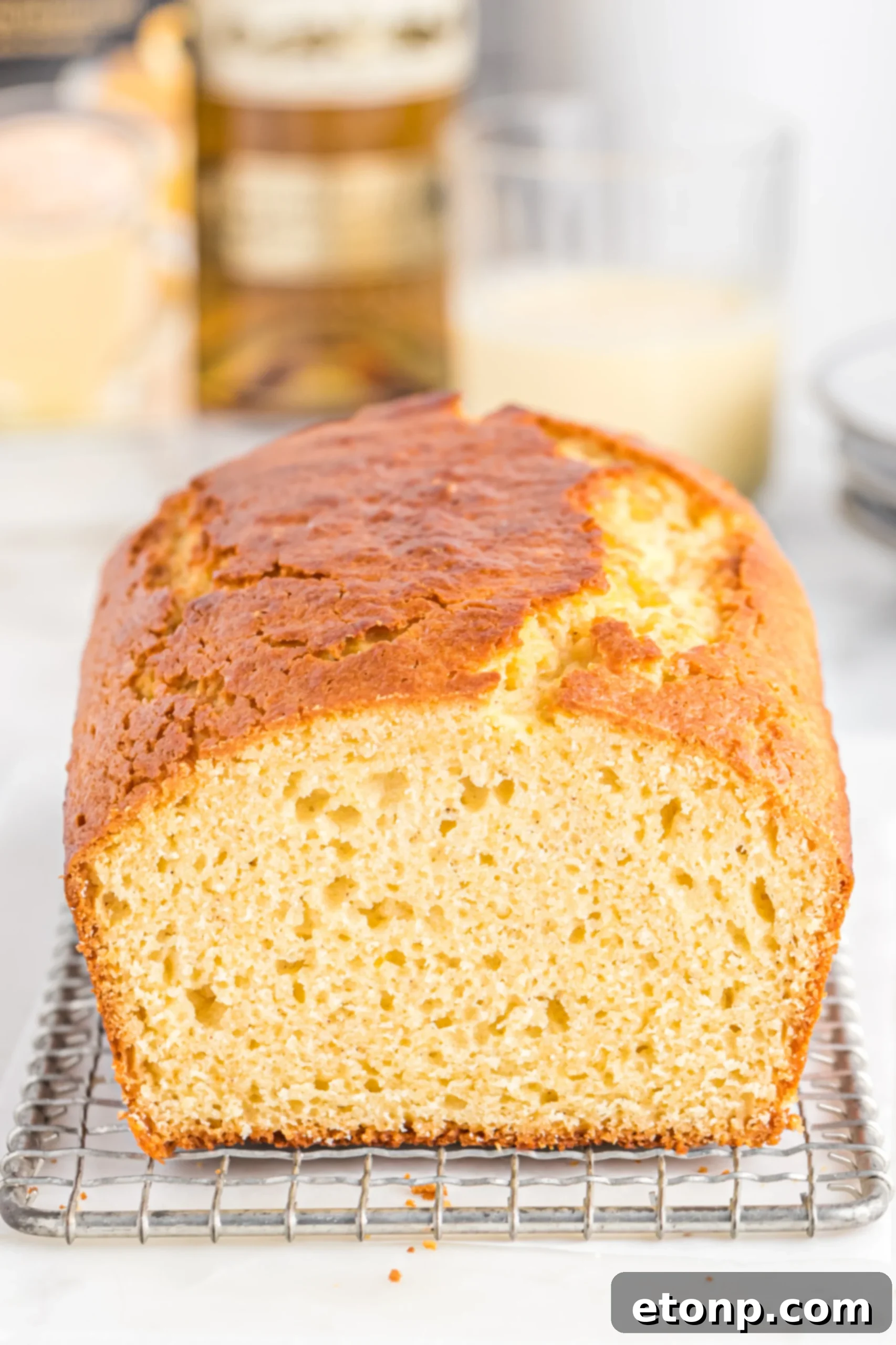 Rum-Drenched Eggnog Loaf 4 A close-up of the moist texture of Boozy Eggnog Bread with glaze drizzled on top