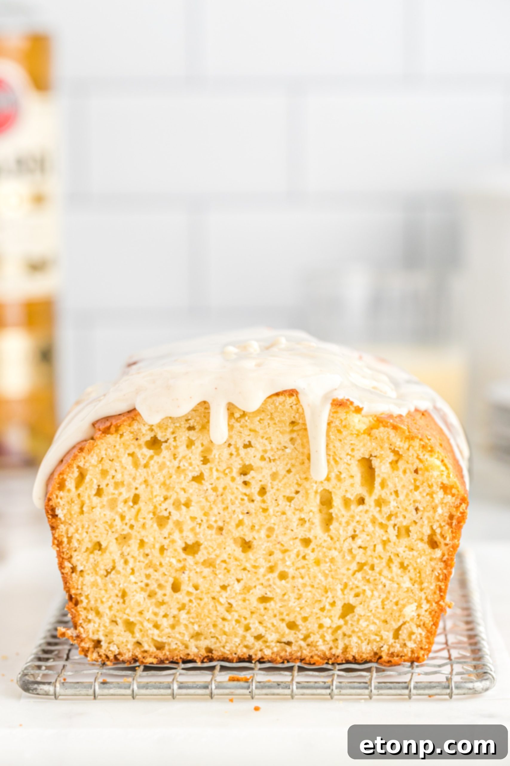 Rum-Drenched Eggnog Loaf 5 Freshly baked Boozy Eggnog Bread cooling on a wire rack, ready for glazing