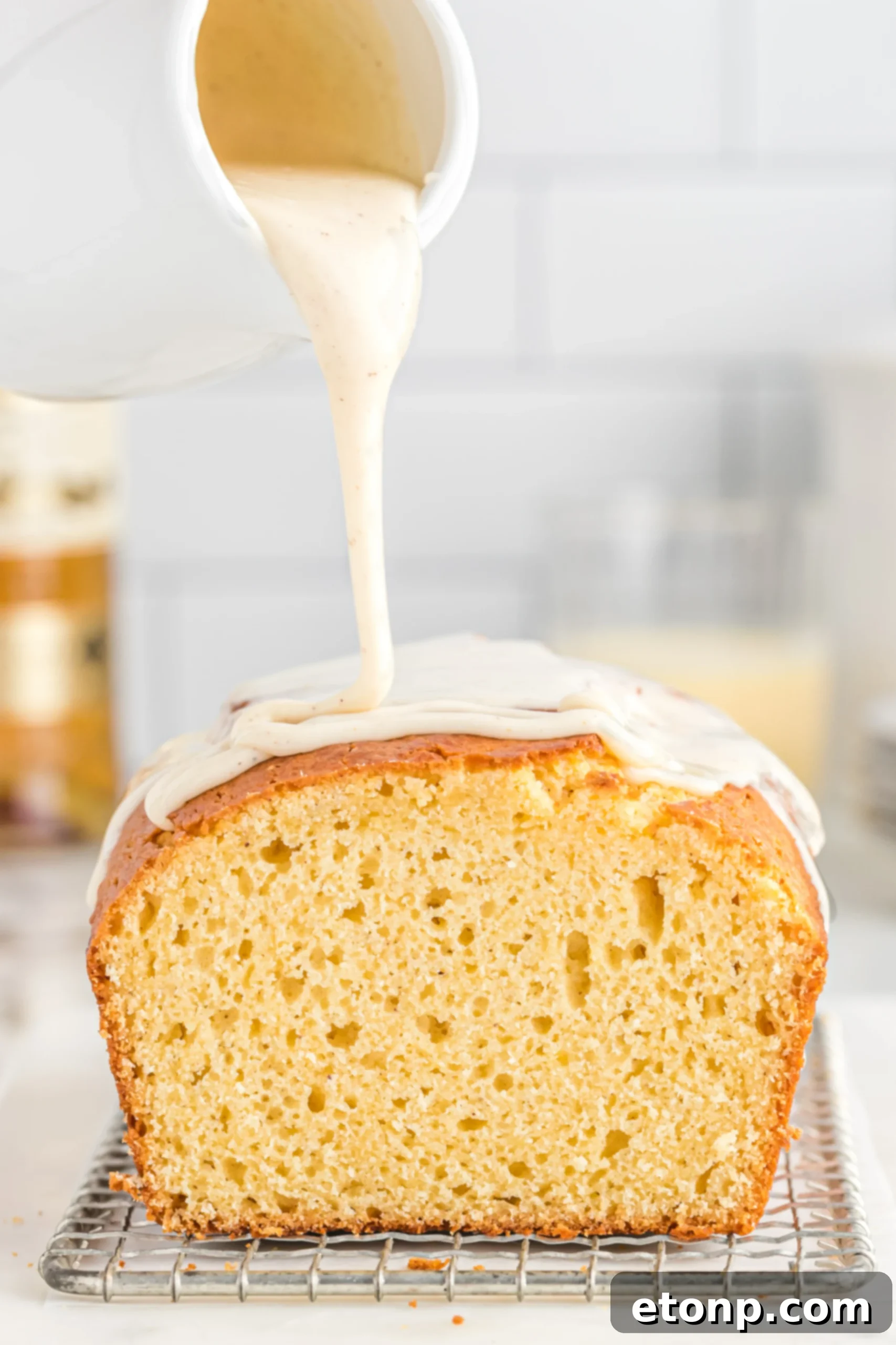 Rum-Drenched Eggnog Loaf 7 A beautifully glazed Boozy Eggnog Bread loaf, garnished with festive sprinkles