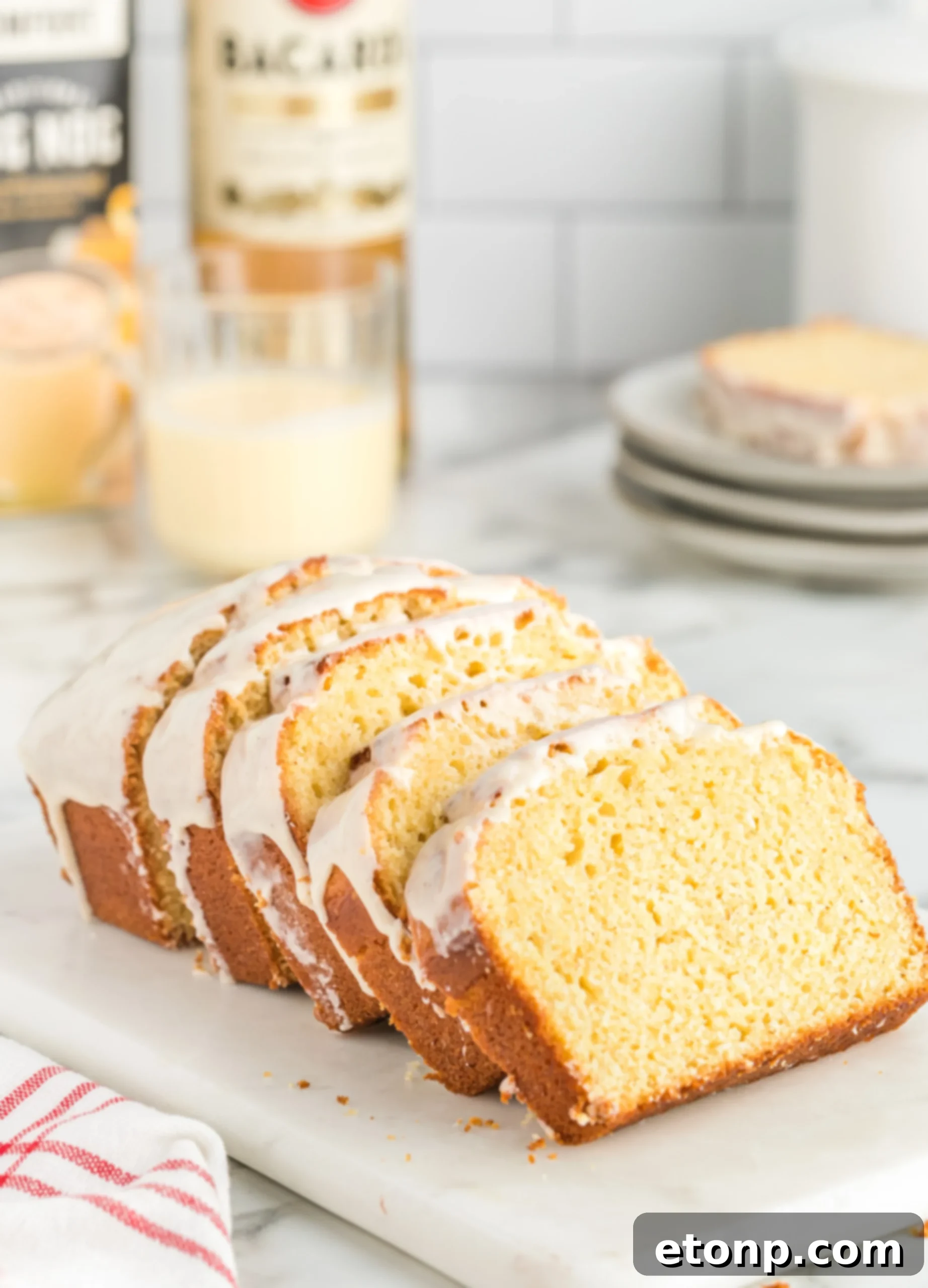 Rum-Drenched Eggnog Loaf 9 A glass of creamy homemade eggnog, garnished with cinnamon stick and nutmeg
