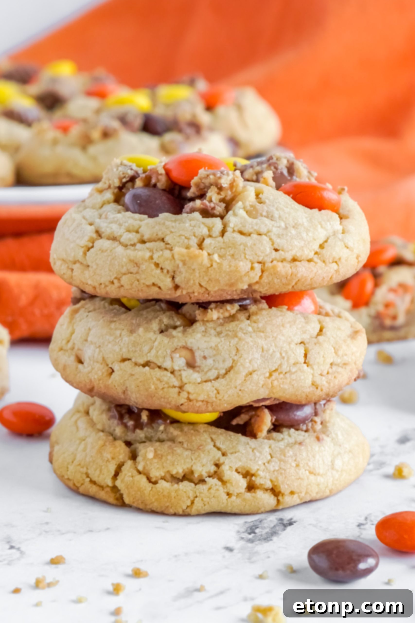 A close-up of a stack of two Reese's Peanut Butter Cup Cookies, ready to be enjoyed.