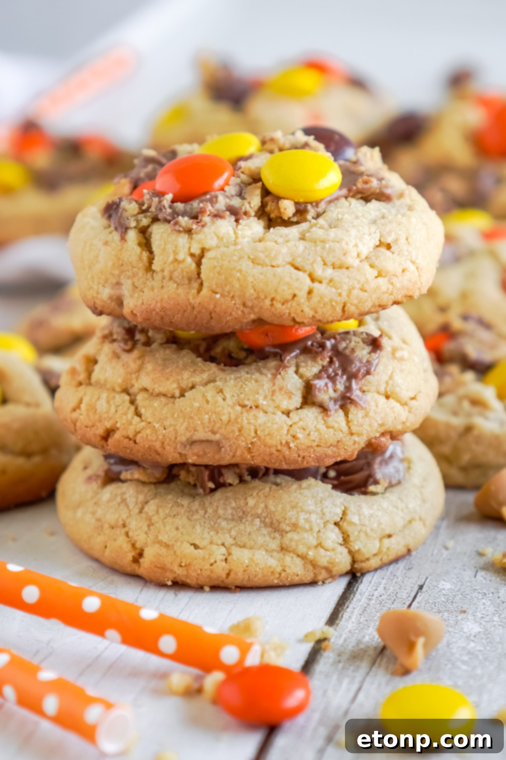 Several Reese's Peanut Butter Cup Cookie dough balls on a baking sheet, ready for the oven.