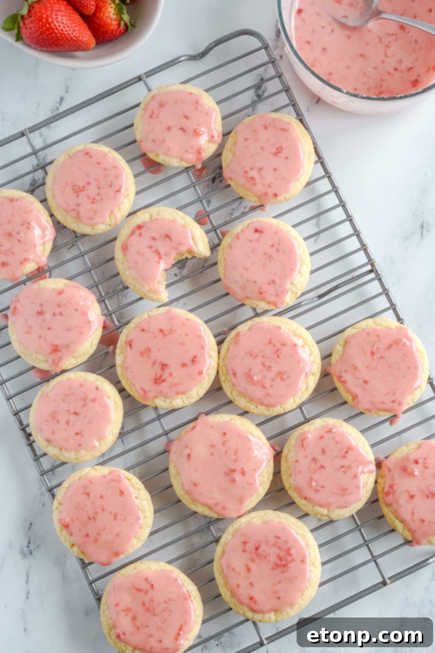Three perfectly glazed Strawberry Sugar Cookies stacked together
