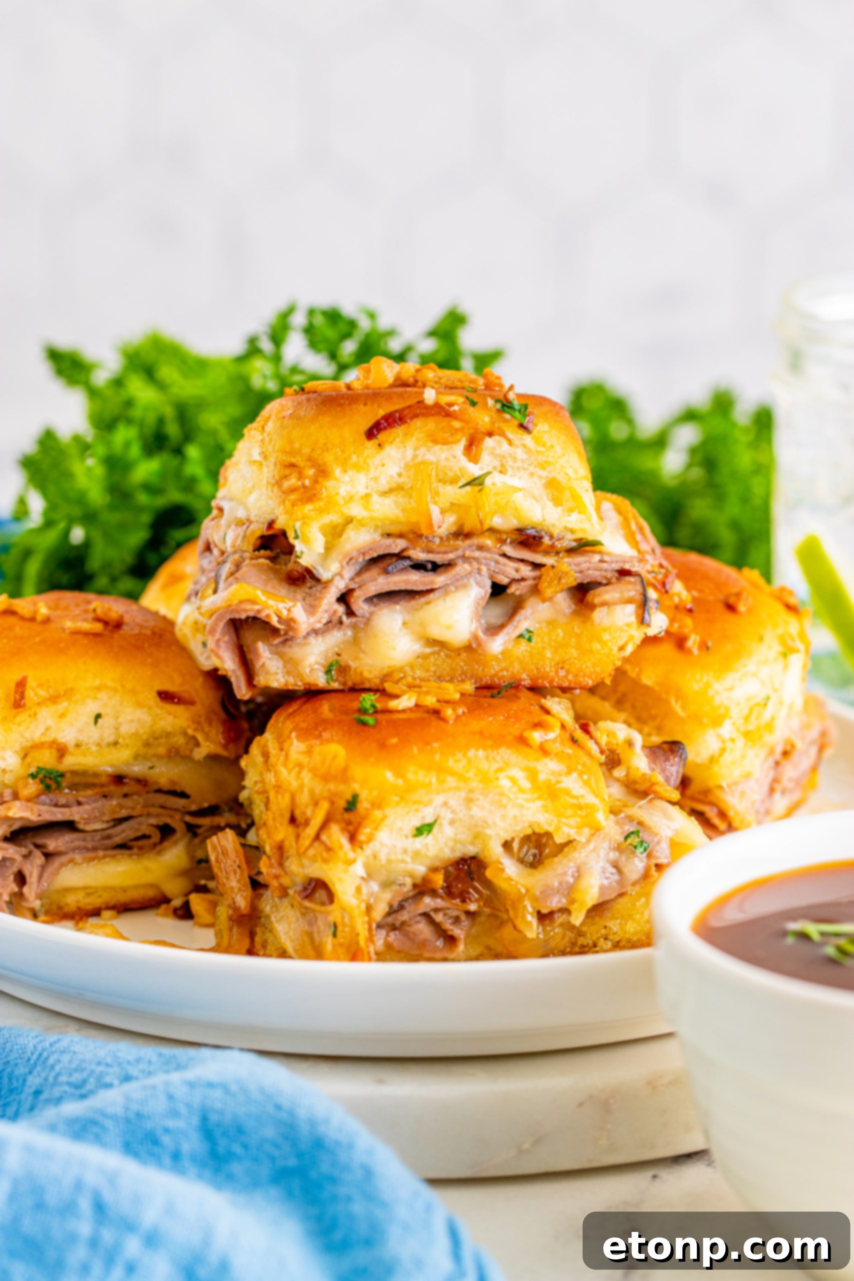 French Dip Sliders served on a white plate, highlighting their appealing presentation.