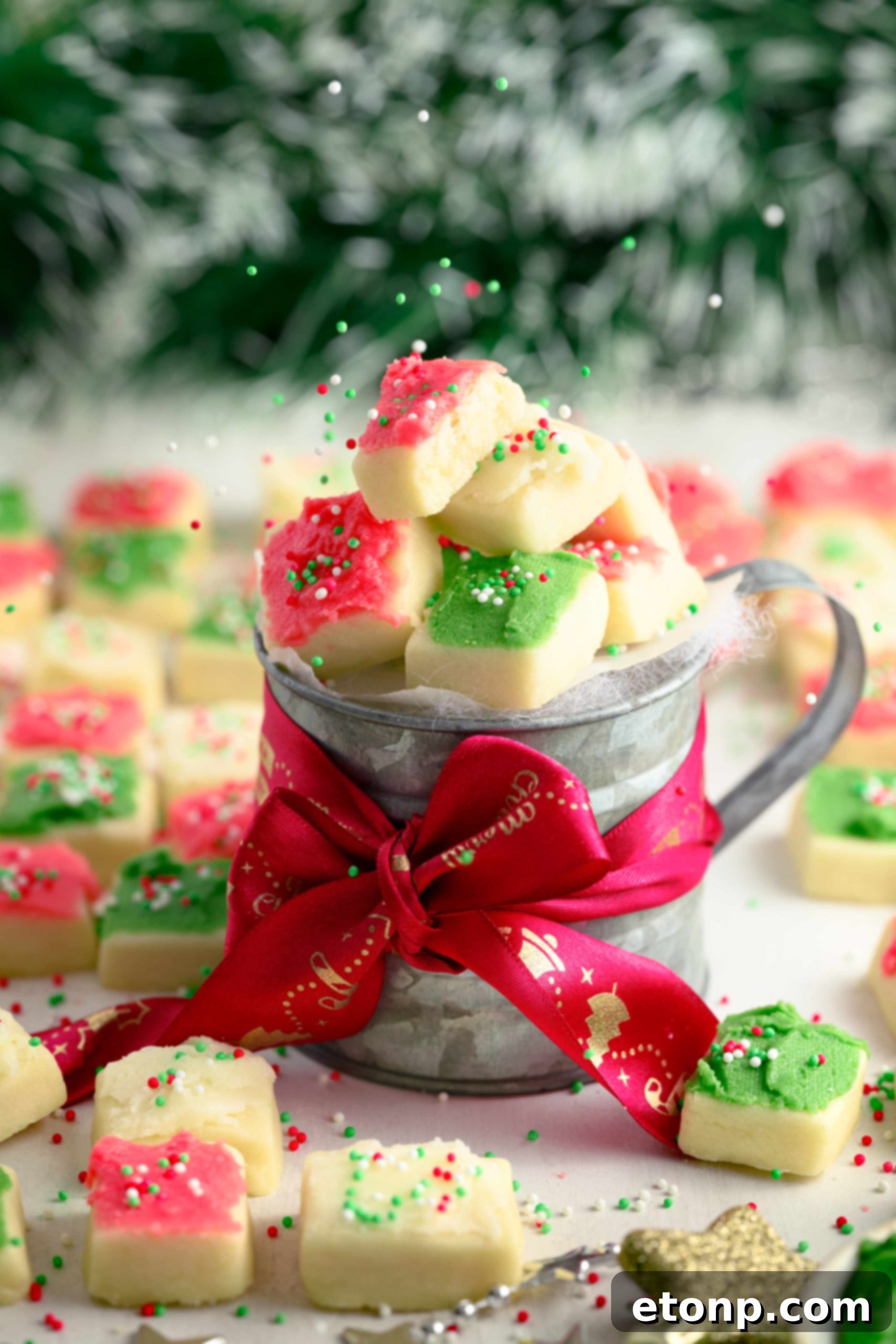 A beautifully frosted green Christmas Sugar Cookie Bite with sprinkles.